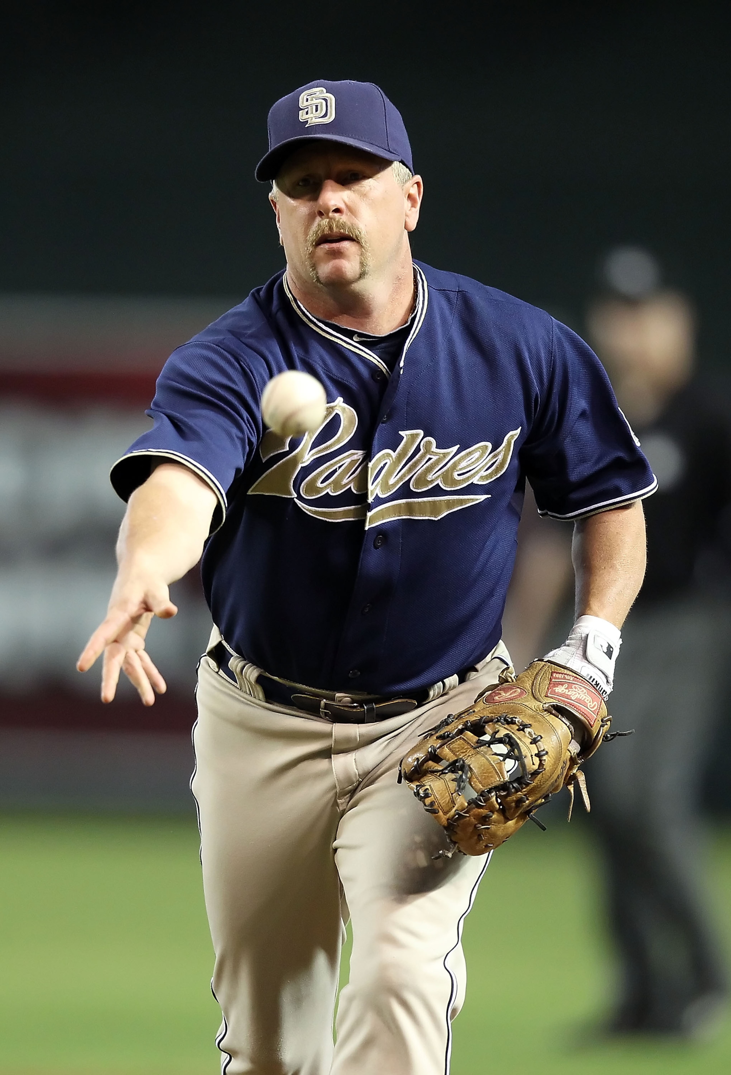 PHOENIX - AUGUST 08:  Infielder Matt Stairs #16 of the San Diego Padres fields a ground ball out agianst the Arizona Diamondbacks during the Major League Baseball game at Chase Field on August 8, 2010 in Phoenix, Arizona.  (Photo by Christian Petersen/Get