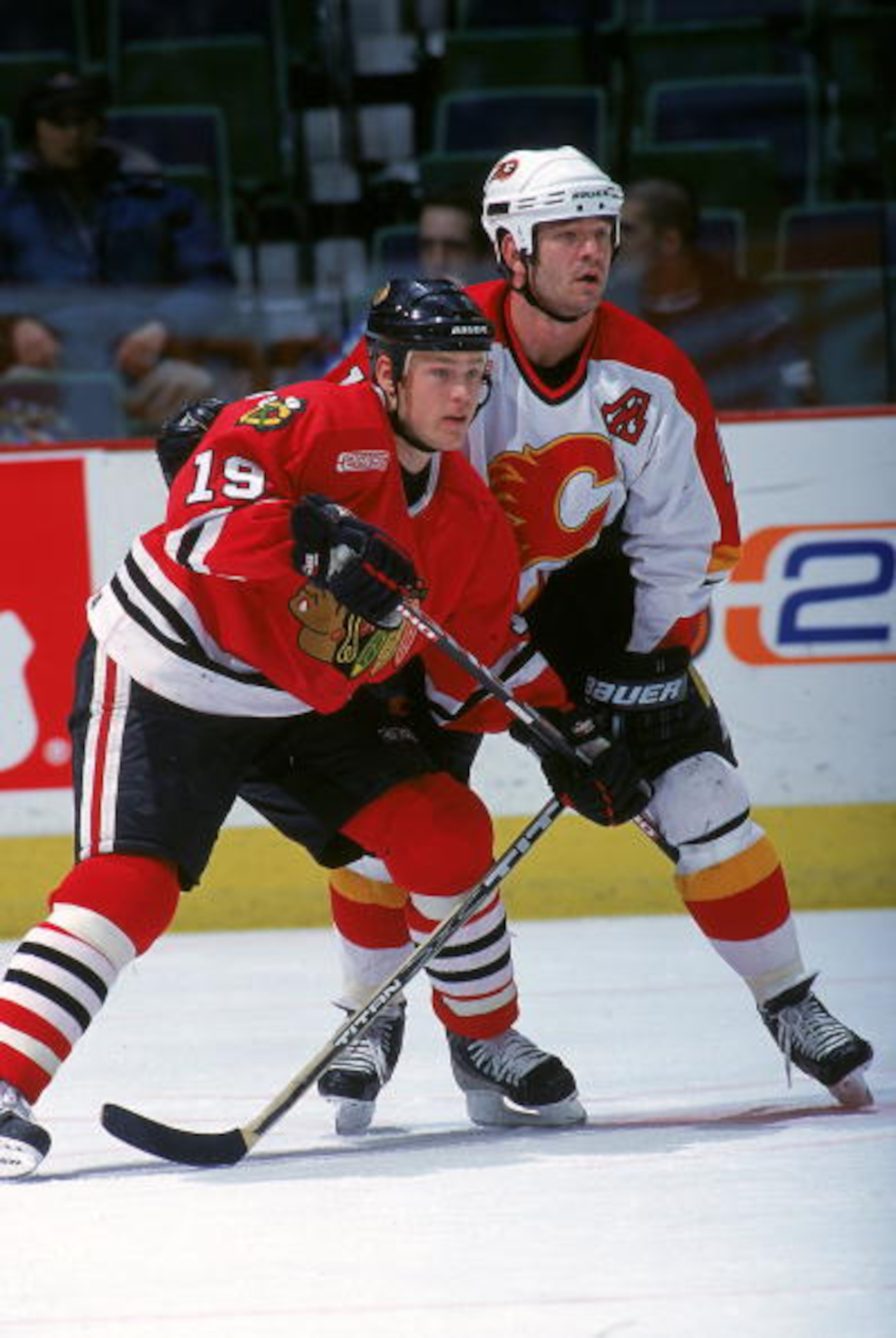 25 Nov 1999:  Dean McAmmond #19 of the Chicago Blackhawks, left, fights for position against the Calgary Flames at the Candian Airlines Saddledome in Calgary, Canada. The Flames defeated the Blackhawks 2-1. Mandatory Credit: Ian Tomlinson  /Allsport