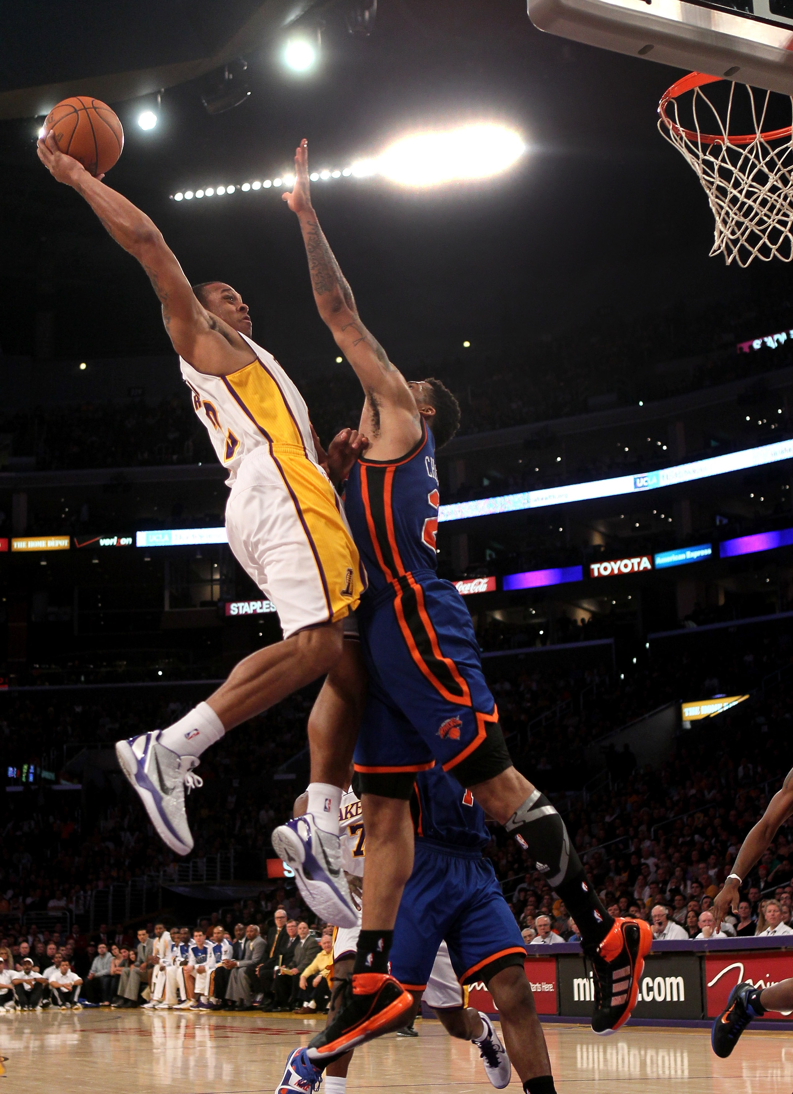 LOS ANGELES, CA - JANUARY 09:  Shannon Brown #12 of the Los Angeles Lakers goes up for a shot against Wilson Chandler #21 of the New York Knicks at Staples Center on January 9, 2011 in Los Angeles, California.  The Lakers won 109-87.   NOTE TO USER: User