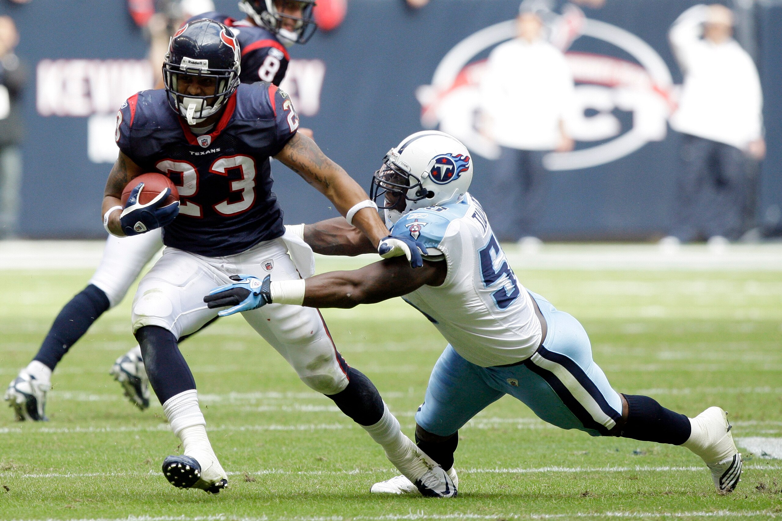 HOUSTON - NOVEMBER 28:  Running back Arian Foster #23 of the Houston Texans avoids a tackle from linebacker Stephen Tulloch #55 of the Tennessee Tians at Reliant Stadium on November 28, 2010 in Houston, Texas.  (Photo by Bob Levey/Getty Images)