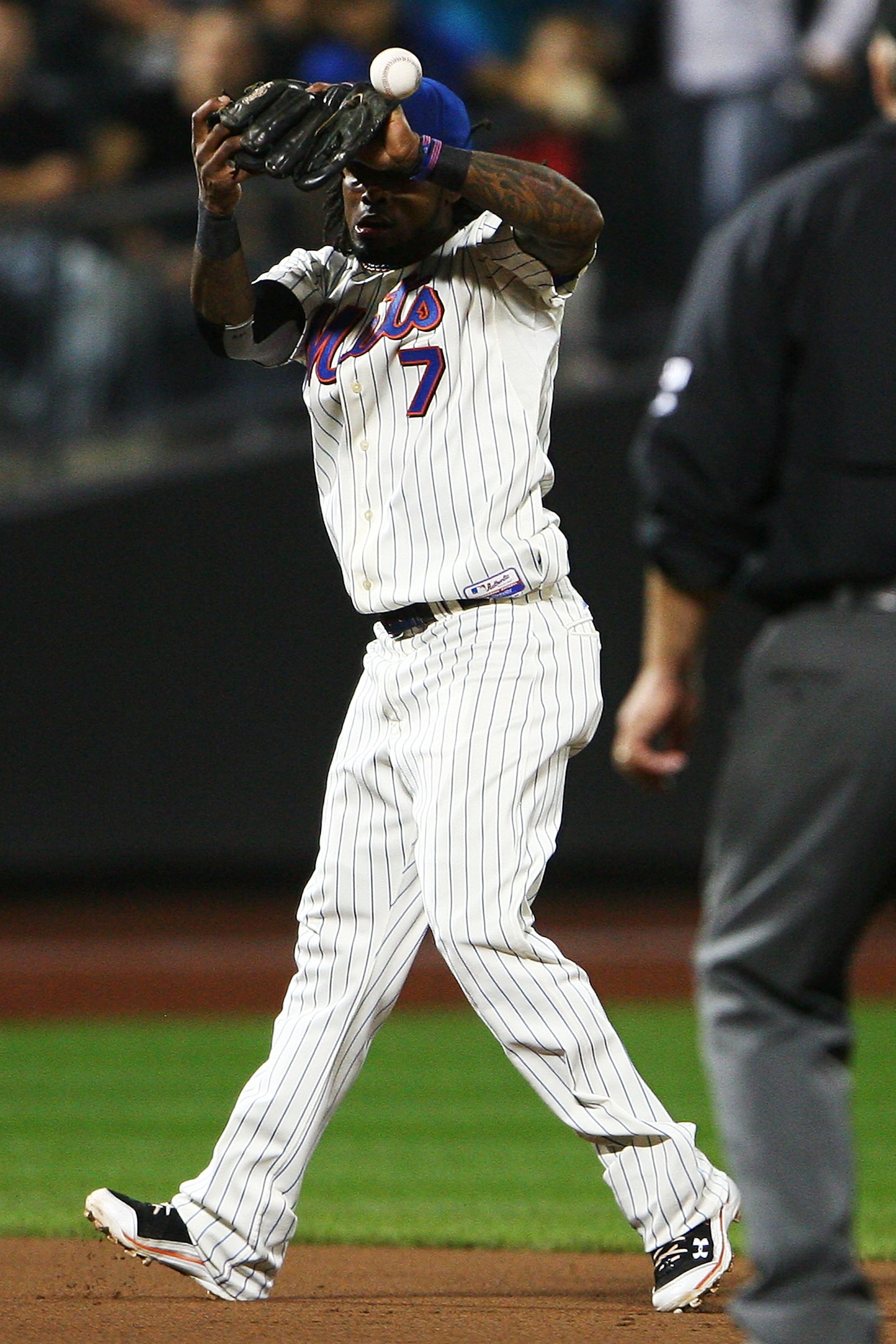 NEW YORK - SEPTEMBER 30:  Jose Reyes #7 of the New York Mets drops a pop fly hit by Corey Hart of the Milwaukee Brewers in the fifth inning on September 30, 2010 at Citi Field in the Flushing neighborhood of the Queens borough of New York City.  (Photo by