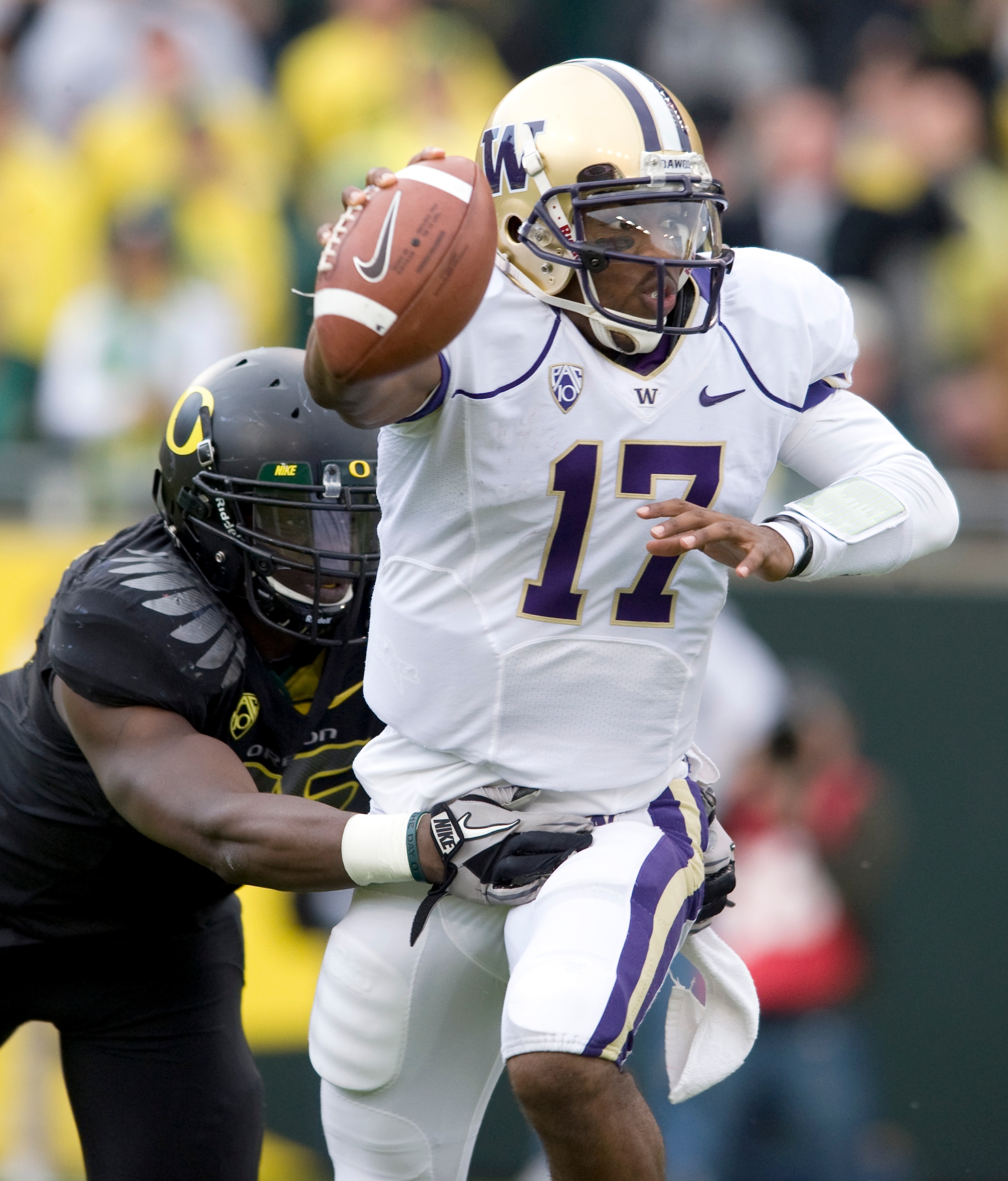 EUGENE, OR - NOVEMBER 6: Quarterback Keith Price #17 of the Washington Huskies is pressured by linebacker Josh Kaddu #56 of the Oregon Ducks in the third quarter of the game at Autzen Stadium on November 6, 2010 in Eugene, Oregon. The Ducks won the game 5