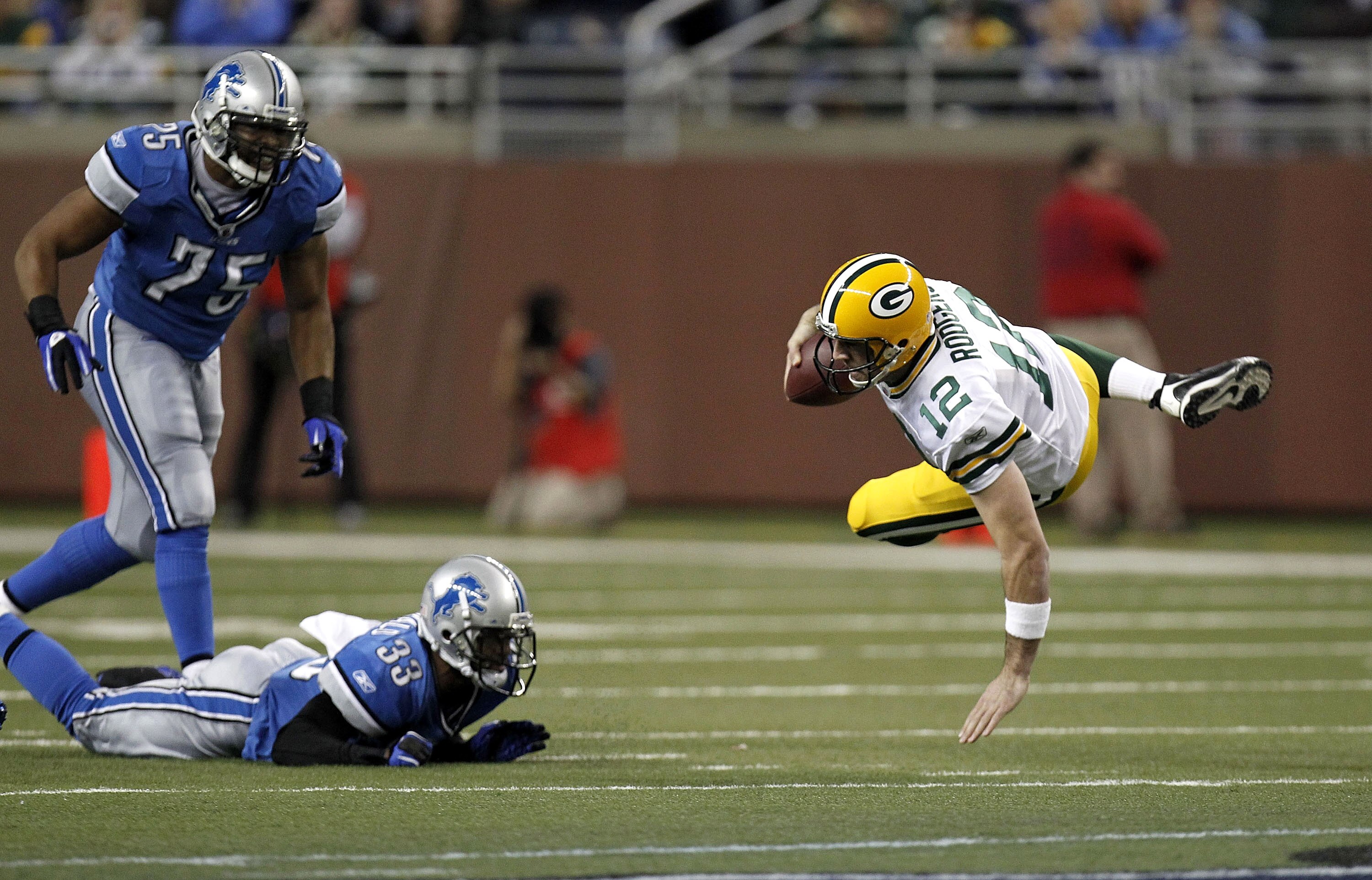 DETROIT, MI - DECEMBER 12:  Aaron Rodgers #12 of the Green Bay Packers is tackled during a second half run by Brandon McDonald #33 of the Detroit Lions on December 12, 2010 at Ford Field in Detroit, Michigan.  (Photo by Gregory Shamus/Getty Images)