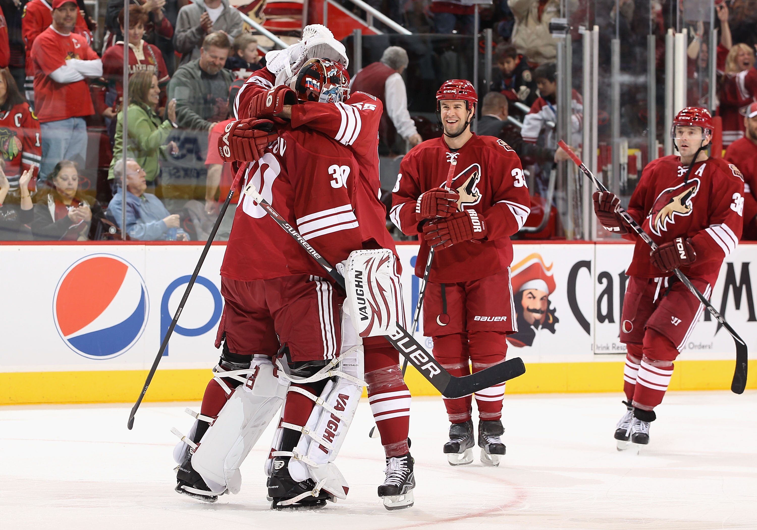 GLENDALE, AZ - FEBRUARY 12:  Goaltender Ilya Bryzgalov #30 of the Phoenix Coyotes hugs teammate Ed Jovanovski #55 after defeating the Chicago Blackhawks in the NHL game at Jobing.com Arena on February 12, 2011 in Glendale, Arizona. The Coyotes defeated th