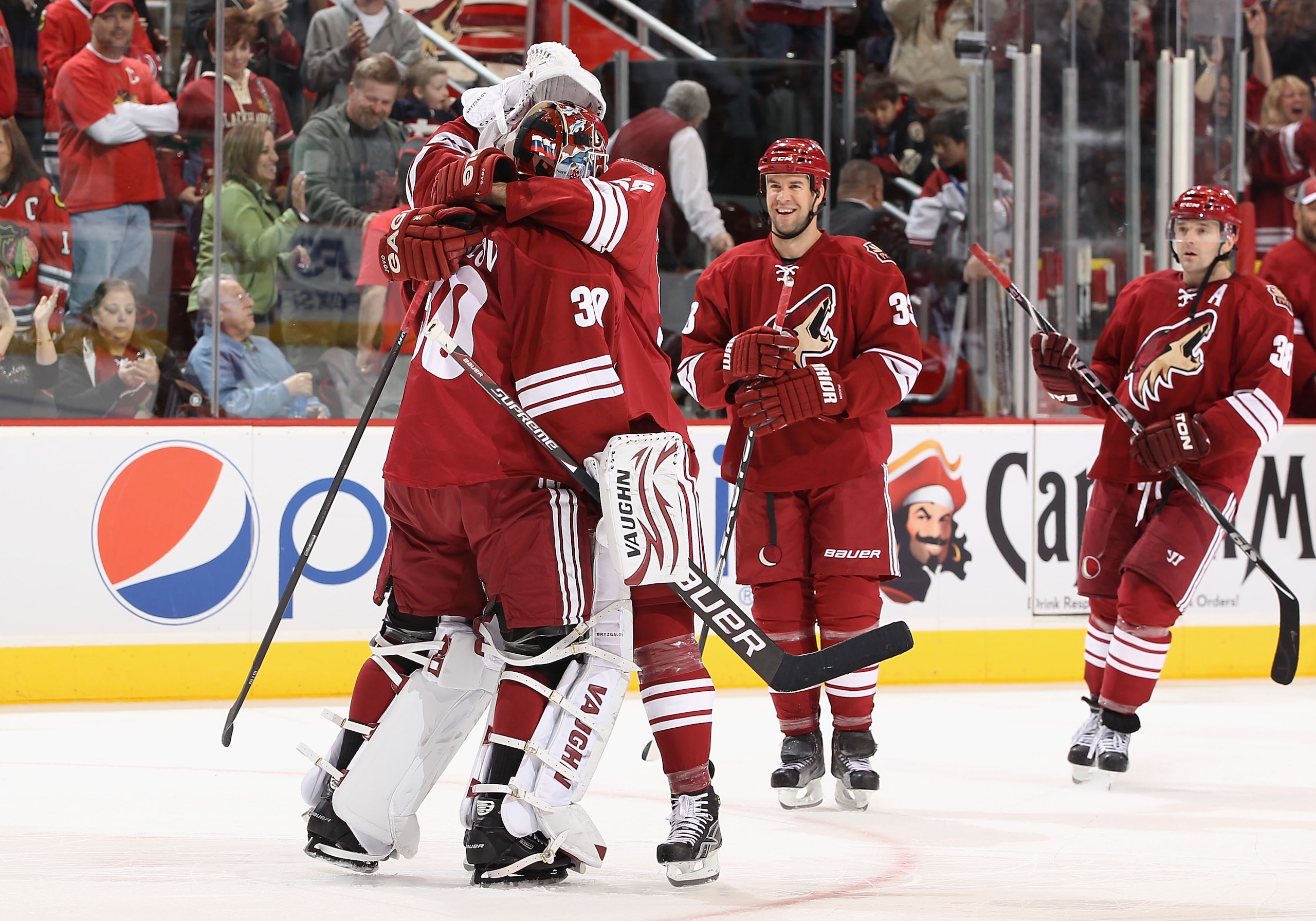 GLENDALE, AZ - FEBRUARY 12:  Goaltender Ilya Bryzgalov #30 of the Phoenix Coyotes hugs teammate Ed Jovanovski #55 after defeating the Chicago Blackhawks in the NHL game at Jobing.com Arena on February 12, 2011 in Glendale, Arizona. The Coyotes defeated th