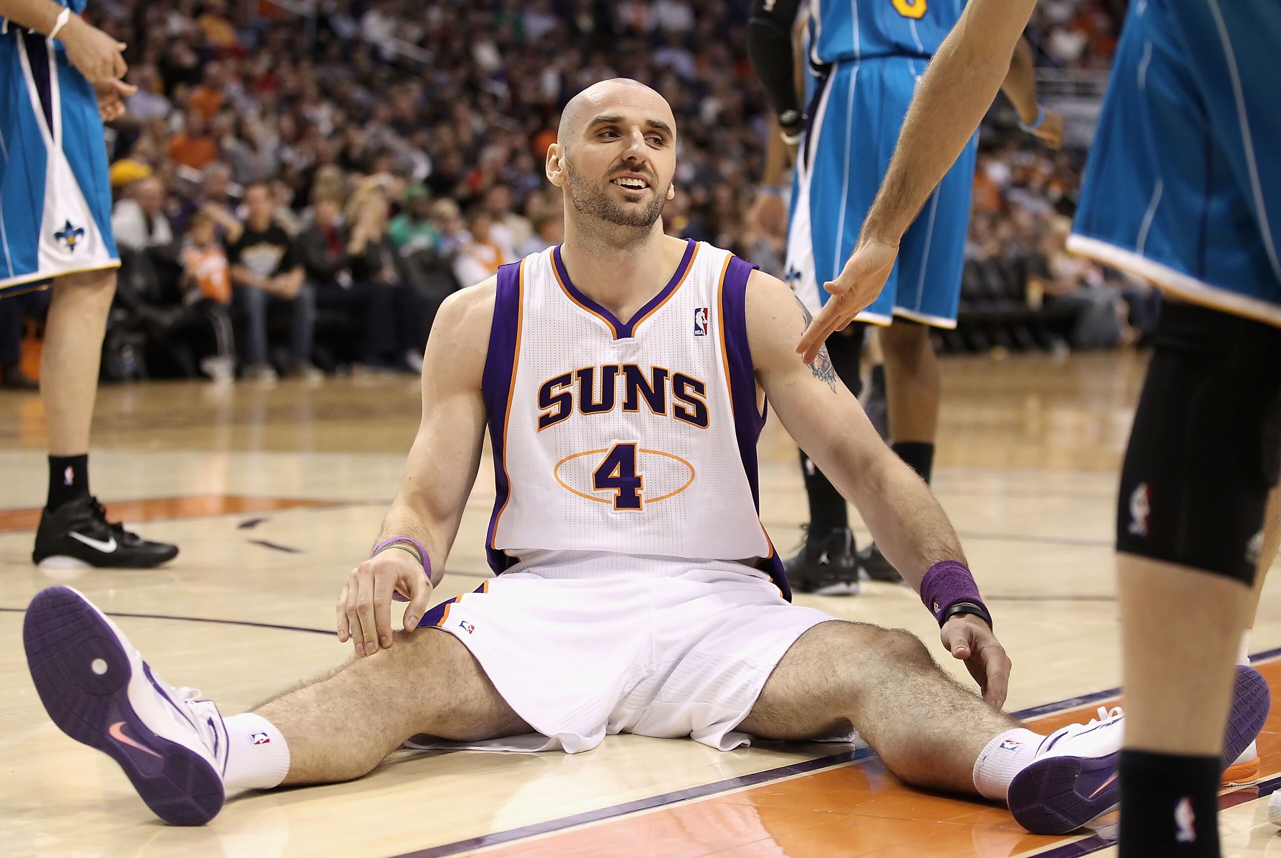 PHOENIX, AZ - JANUARY 30:  Marcin Gortat #4 of the Phoenix Suns reacts after falling to the court during the NBA game against the New Orleans Hornets at US Airways Center on January 30, 2011 in Phoenix, Arizona. The Suns defeated the Hornets 104-102.   NO