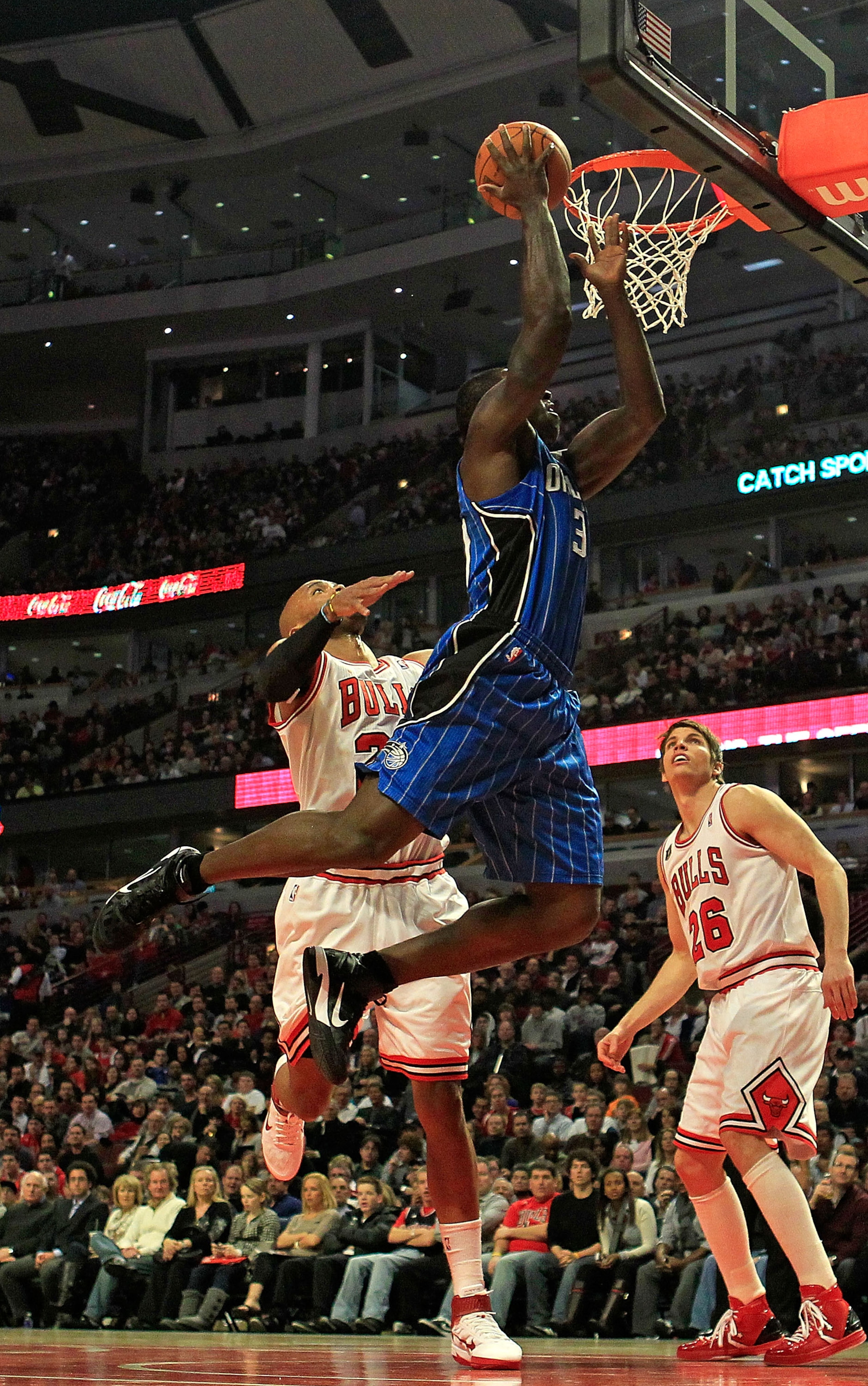CHICAGO, IL - JANUARY 28: Brandon Bass #30 of the Orlando Magic goes up for a shot over Taj Gibson #22 and Kyle Korver #26 of the Chicago Bulls at the United Center on January 28, 2011 in Chicago, Illinois. NOTE TO USER: User expressly acknowledges and ag