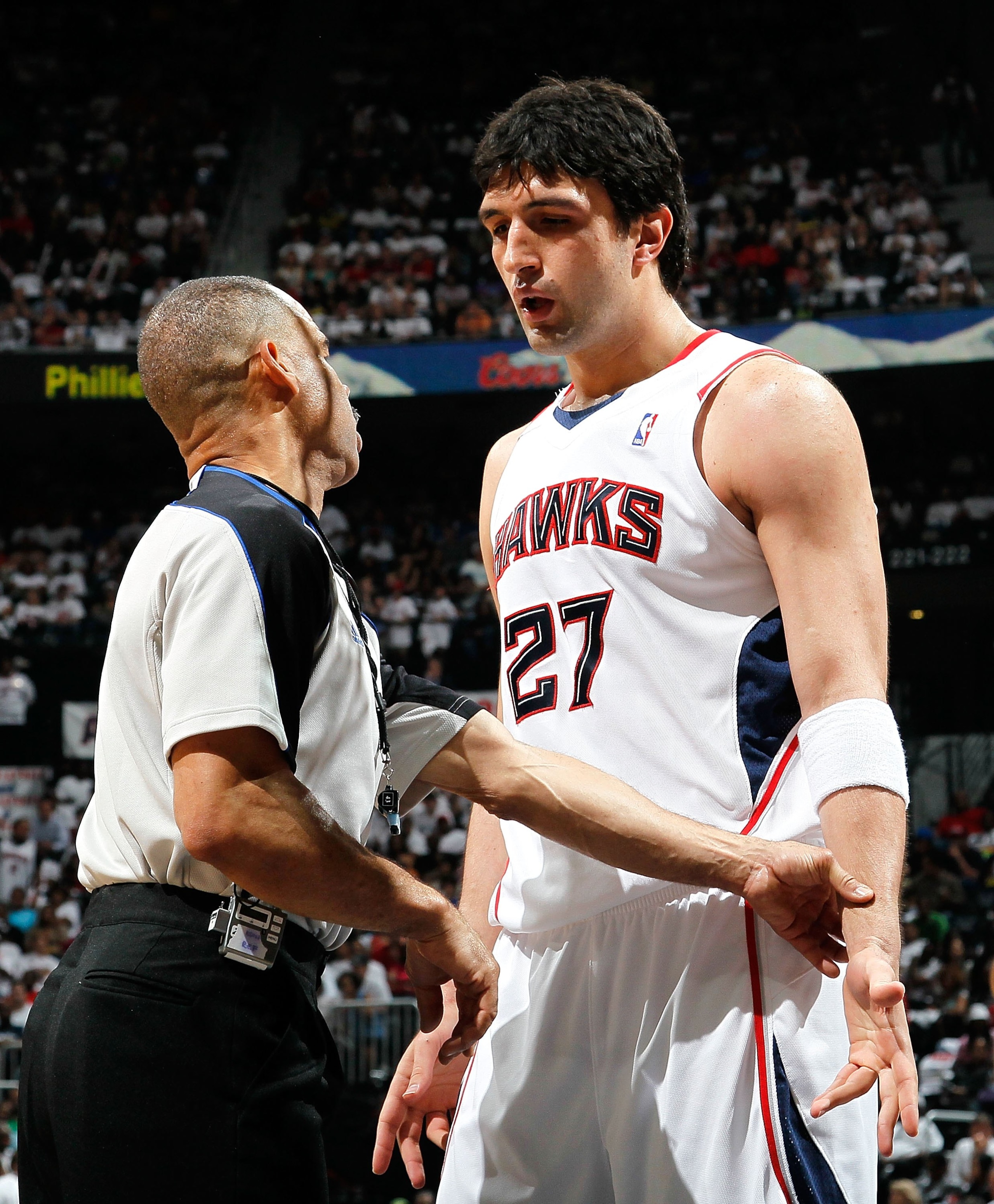 ATLANTA - MAY 08:  Referee Dan Crawford #43 converses with Zaza Pachulia #27 of the Atlanta Hawks against the Orlando Magic during Game Three of the Eastern Conference Semifinals during the 2010 NBA Playoffs at Philips Arena on May 8, 2010 in Atlanta, Geo