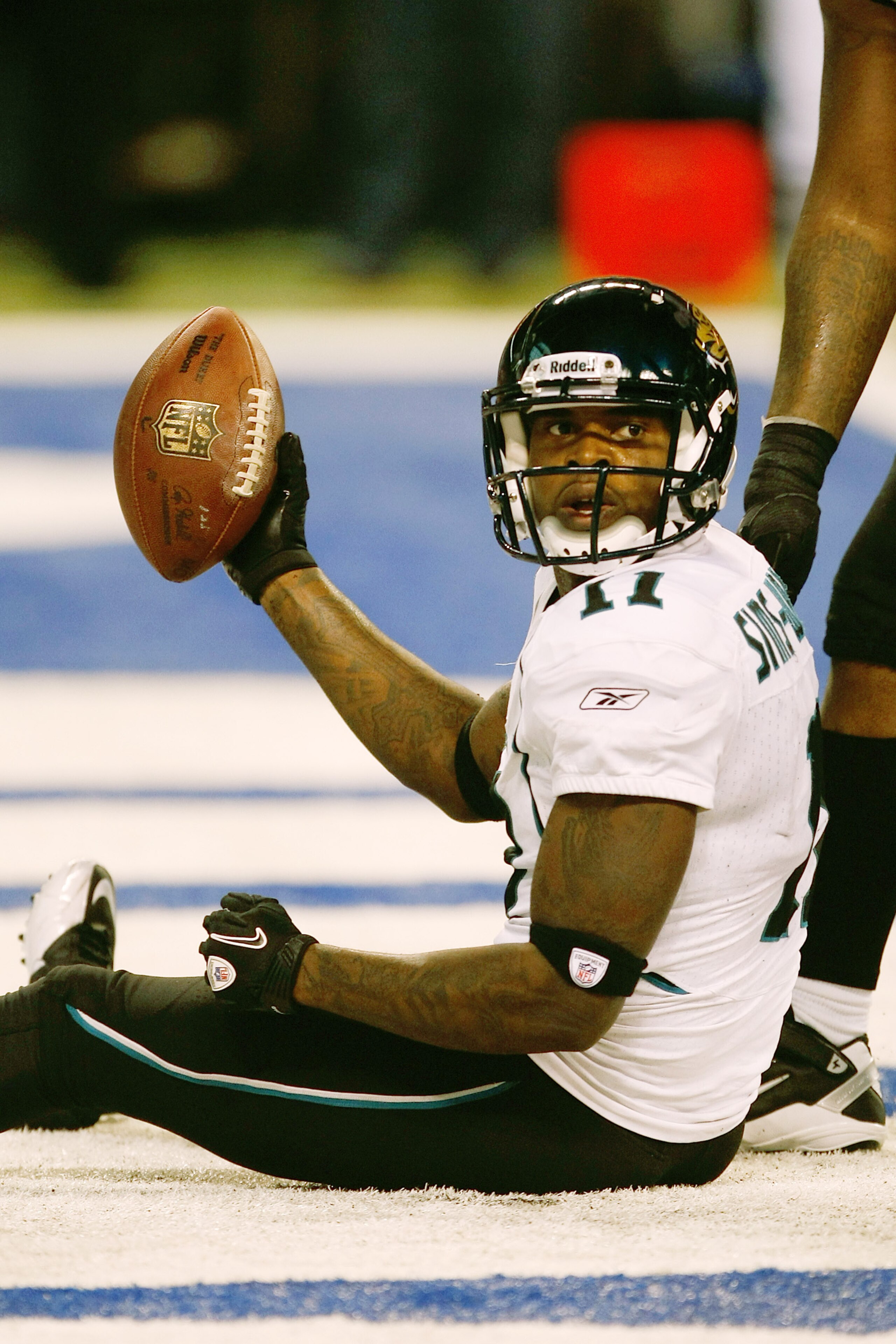 INDIANAPOLIS, IN - DECEMBER 19: Mike Sims-Walker #11 of the Jacksonville Jaguars holds up the football after scoring a touchdown against the Indianapolis Colts at Lucas Oil Stadium on December 19, 2010 in Indianapolis, Indiana. The Colts defeated the Jagu