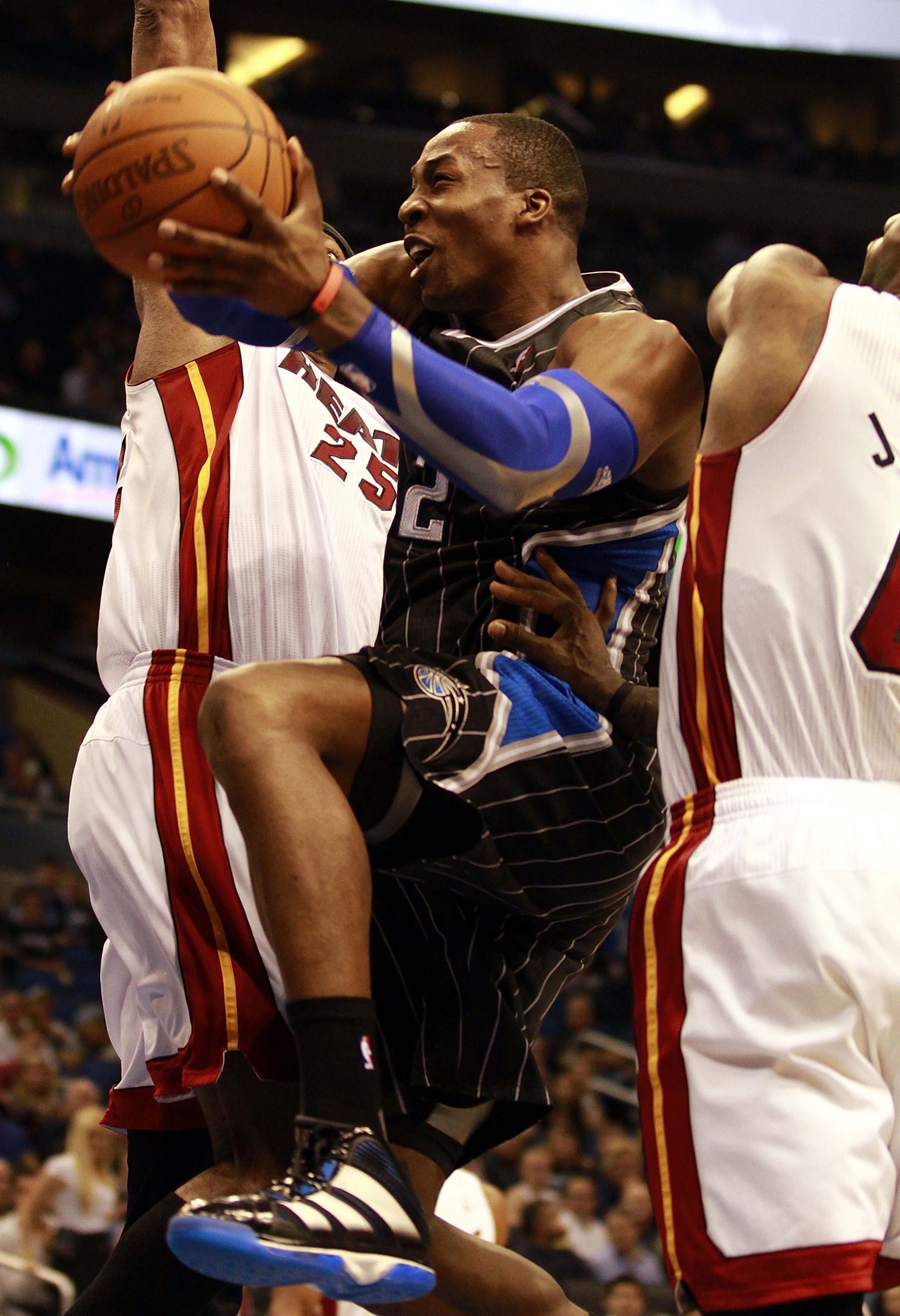 ORLANDO, FL - FEBRUARY 03:  Center Dwight Howard #12 of the Orlando Magic drives against the Miami Heat at Amway Arena on February 3, 2011 in Orlando, Florida. NOTE TO USER: User expressly acknowledges and agrees that, by downloading and or using this pho