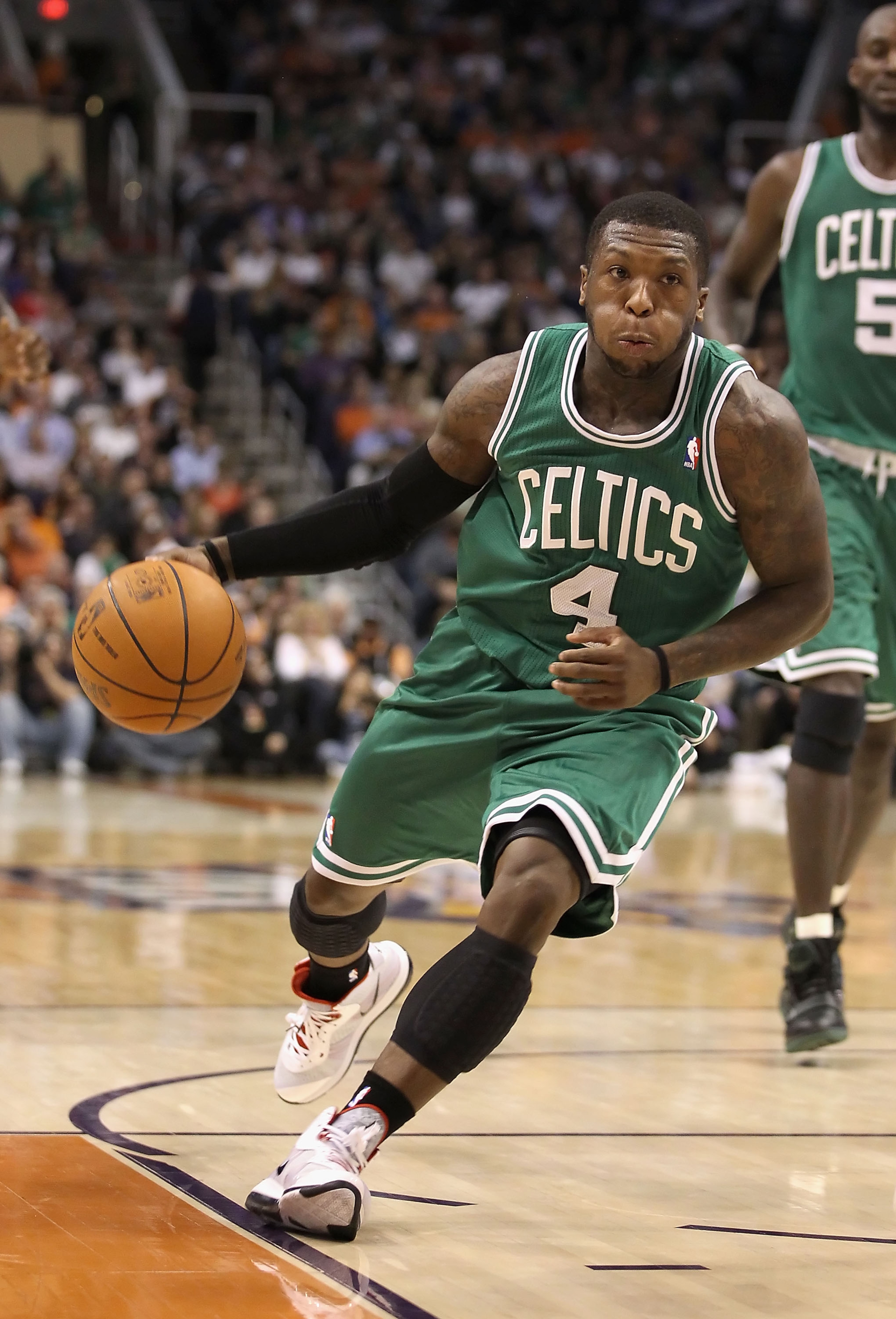 PHOENIX, AZ - JANUARY 28: Nate Robinson #4 of the Boston Celtics handles the ball during the NBA game against the Phoenix Suns at US Airways Center on January 28, 2011 in Phoenix, Arizona. The Suns defeated the Celtics 88-71. NOTE TO USER: User expressly PHOENIX, AZ - JANUARY 28: Nate Robinson #4 of the Boston Celtics handles the ball during the NBA game against the Phoenix Suns at US Airways Center on January 28, 2011 in Phoenix, Arizona. The Suns defeated the Celtics 88-71. NOTE TO USER: User expressly