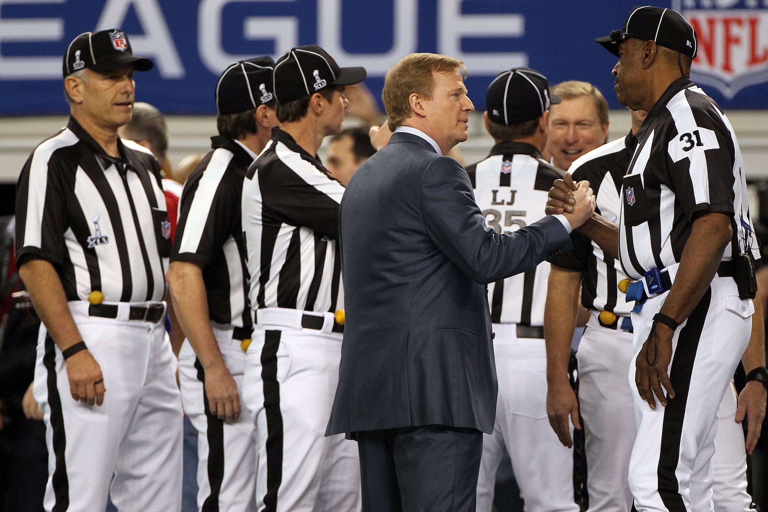 ARLINGTON, TX - FEBRUARY 06:  Roger Goodell, the commisioner of the NFL, talks with umpire Chad Brown #31 before the Pittsburgh Steelers take on the Green Bay Packers in Super Bowl XLV at Cowboys Stadium on February 6, 2011 in Arlington, Texas.  (Photo by