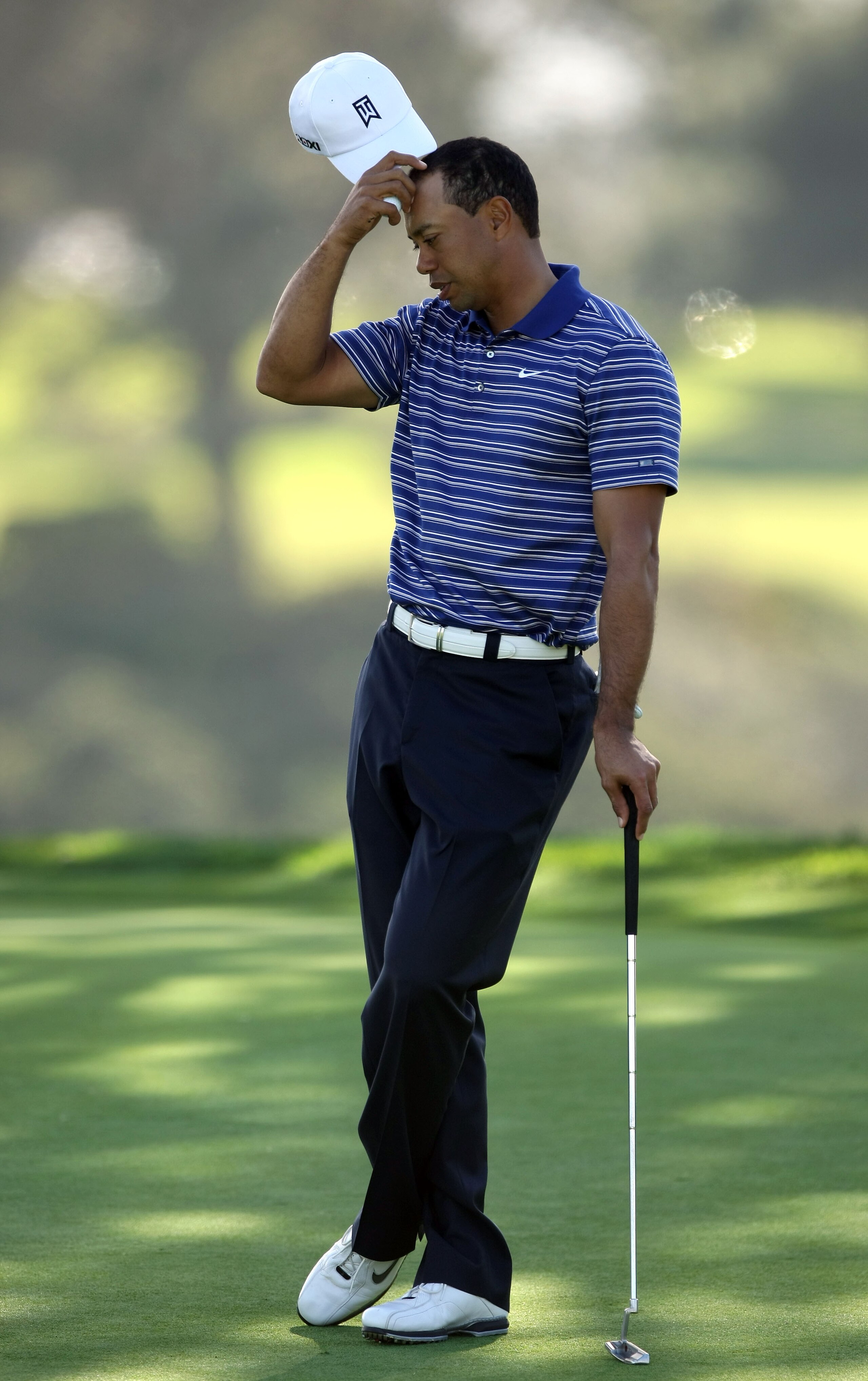 LA JOLLA, CA - JANUARY 26:  Tiger Woods scratches his head as he wait for a putt during the Pro-Am at the Farmers Insurance Open at Torrey Pines on January 26, 2011 in La Jolla, California. (Photo by Donald Miralle/Getty Images)