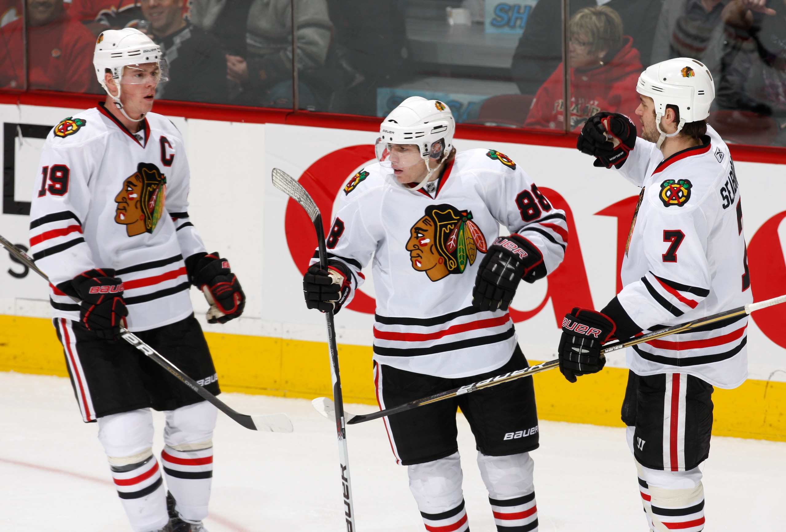 CALGARY, CANADA - FEBRUARY 7: Patrick Kane #88 of the Chicago Black Hawks celebrates with Jonathon Toews #19 and Brent Seakbrooke #7 in second period action against the Calgary Flames at Scotiabank Saddledome February 7, 2011 in Calgary, Alberta, Canada.