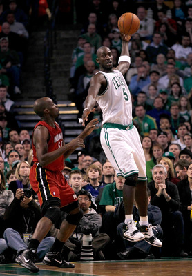 BOSTON - FEBRUARY 13:  Kevin Garnett #5 of the Boston Celtics catches a pass against Joel Anthony #50 of the Miami Heat at TD Garden on February 13, 2011 in Boston, Massachusetts. The Celtics won 85-82. NOTE TO USER: User expressly acknowledges and agrees