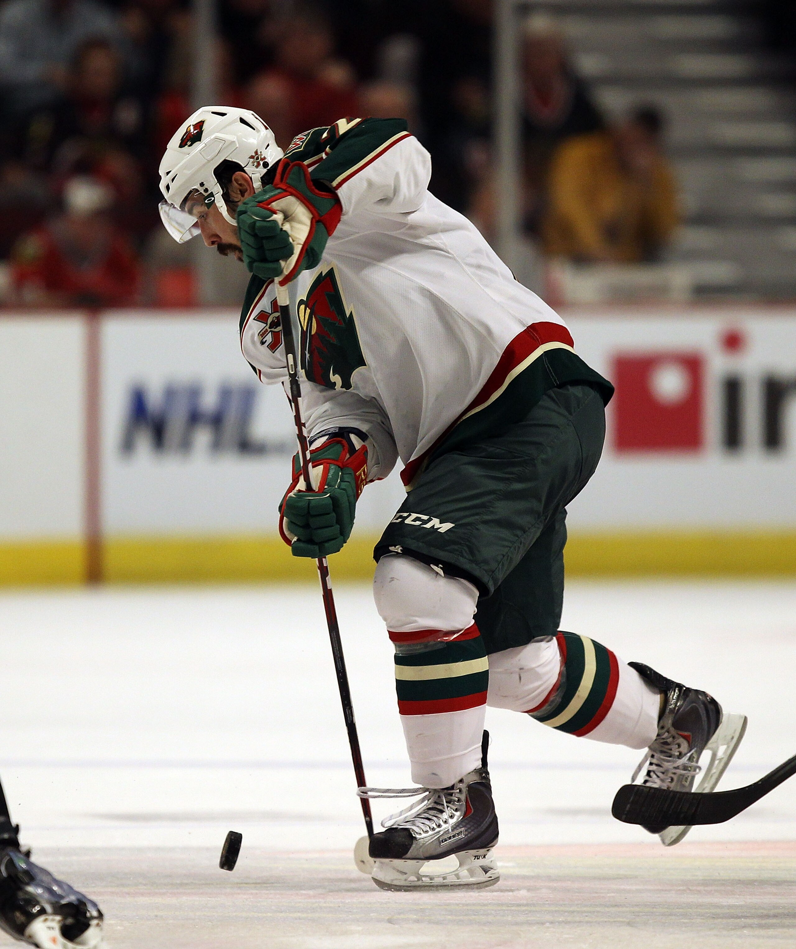 CHICAGO, IL - JANUARY 25: Cal Clutterbuck #22 of the Minnesota Wild controls the puck against the Chicago Blackhawks at the United Center on January 25, 2011 in Chicago, Illinois. The Wild defeated the Blackhawks 4-2. (Photo by Jonathan Daniel/Getty Image