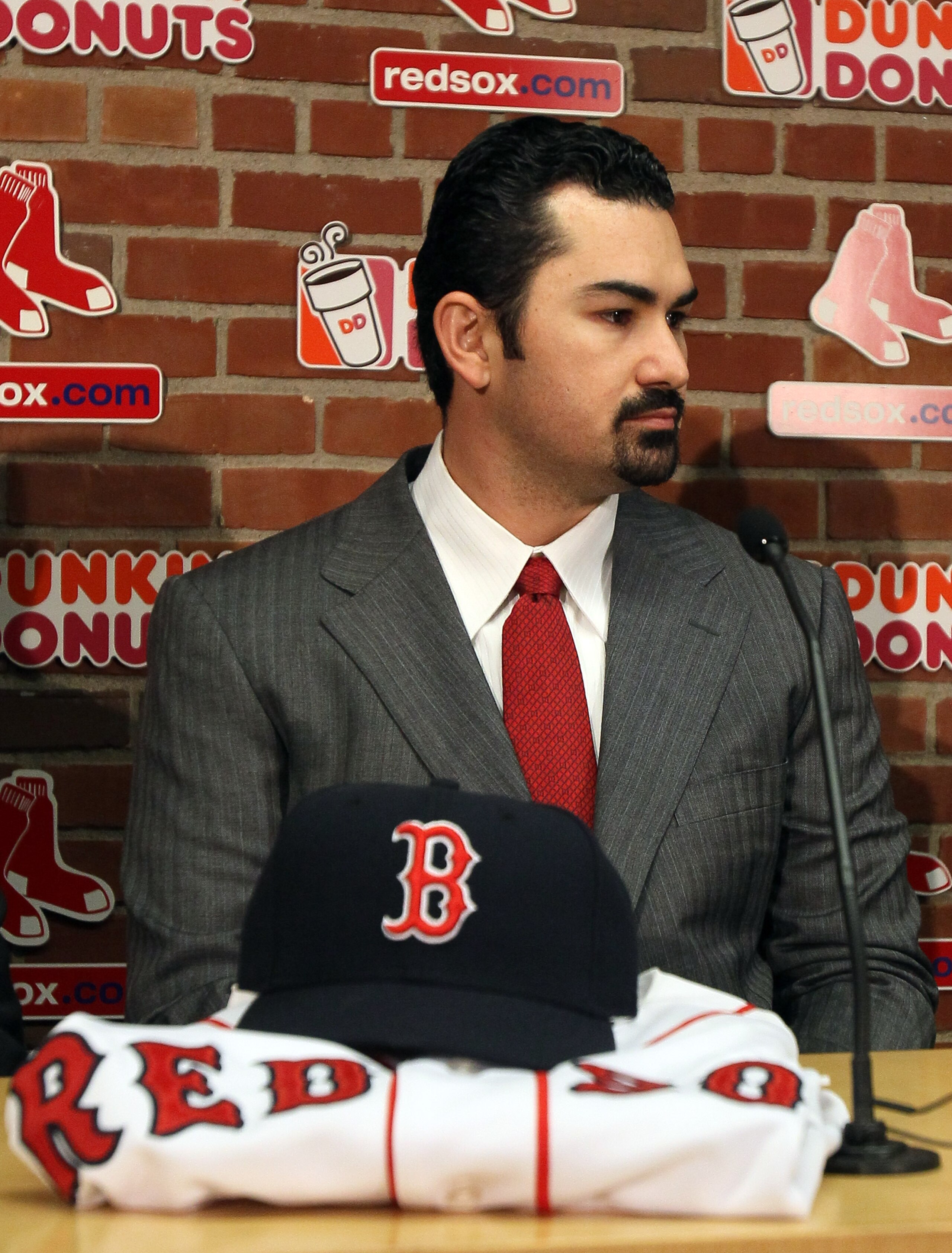 BOSTON, MA - DECEMBER 06: Adrian Gonzalez answers questions during a press conference to announce his signing with the Boston Red Sox on December 6, 2010 at Fenway Park in Boston, Massachusetts. (Photo by Elsa/Getty Images) BOSTON, MA - DECEMBER 06: Adrian Gonzalez answers questions during a press conference to announce his signing with the Boston Red Sox on December 6, 2010 at Fenway Park in Boston, Massachusetts. (Photo by Elsa/Getty Images)
