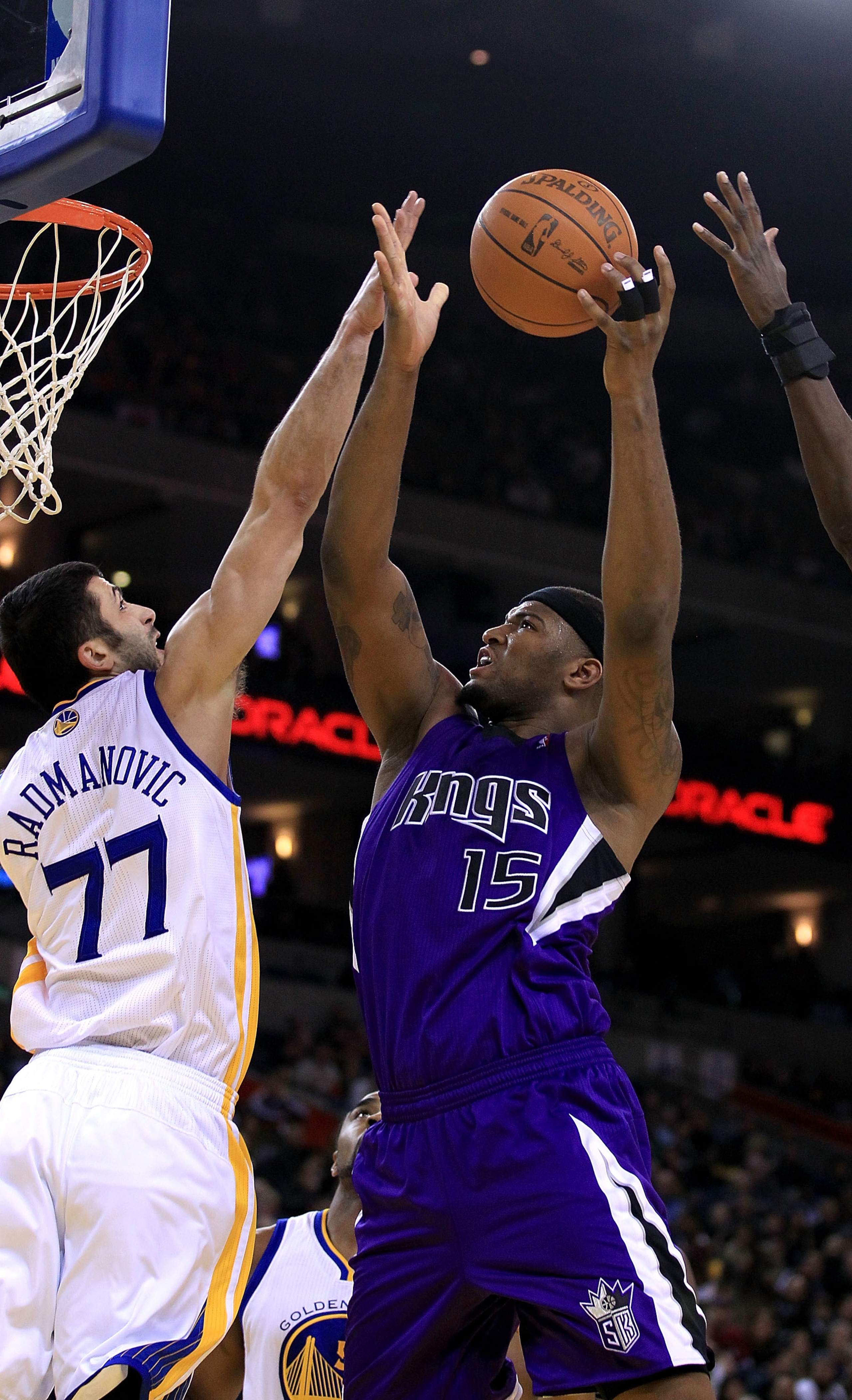 OAKLAND, CA - JANUARY 21:  DeMarcus Cousins #15 of the Sacramento Kings goes up for a shot against Vladimir Radmanovic #77 of the Golden State Warriors at Oracle Arena on January 21, 2011 in Oakland, California. NOTE TO USER: User expressly acknowledges a