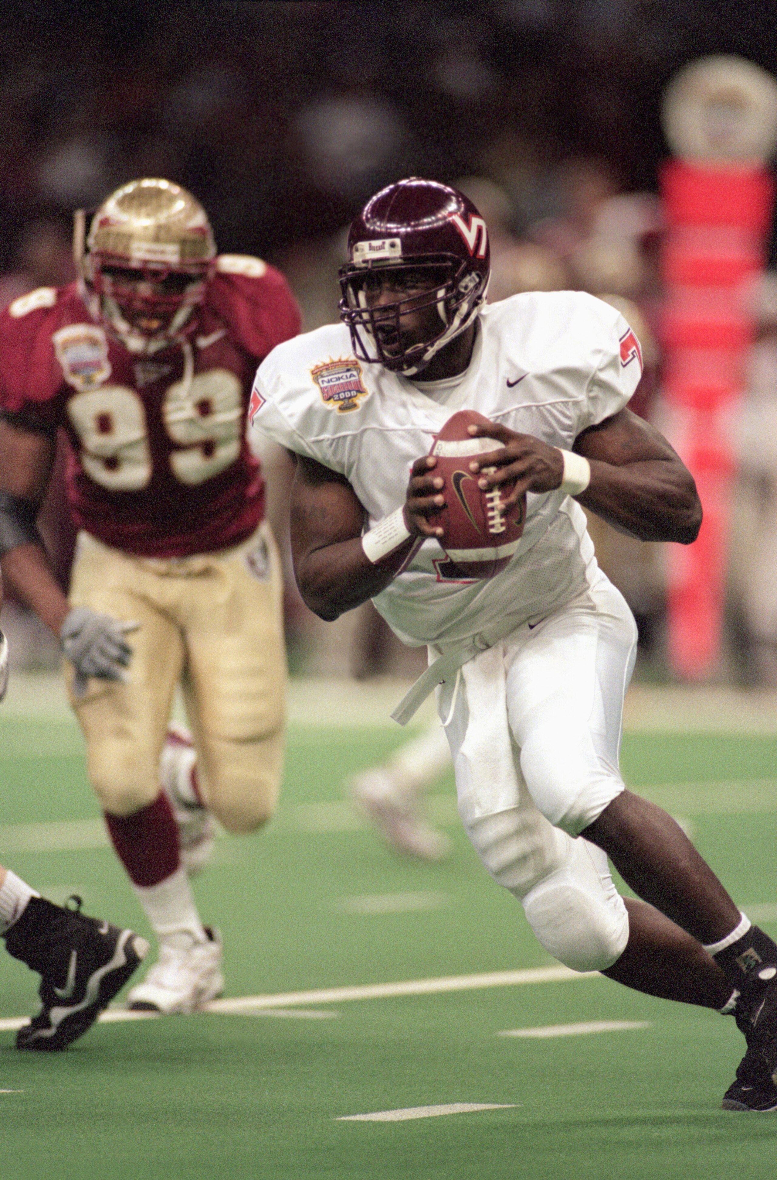 NEW ORLEANS - JANUARY 4:  Quarterback Michael Vick #7 of the Virginia Tech Hokies scrambles left and looks to make a play with the ball against the Florida State Seminoles during the Nokia Sugar Bowl on January 4, 2000 at the Louisiana SuperDome in New Or