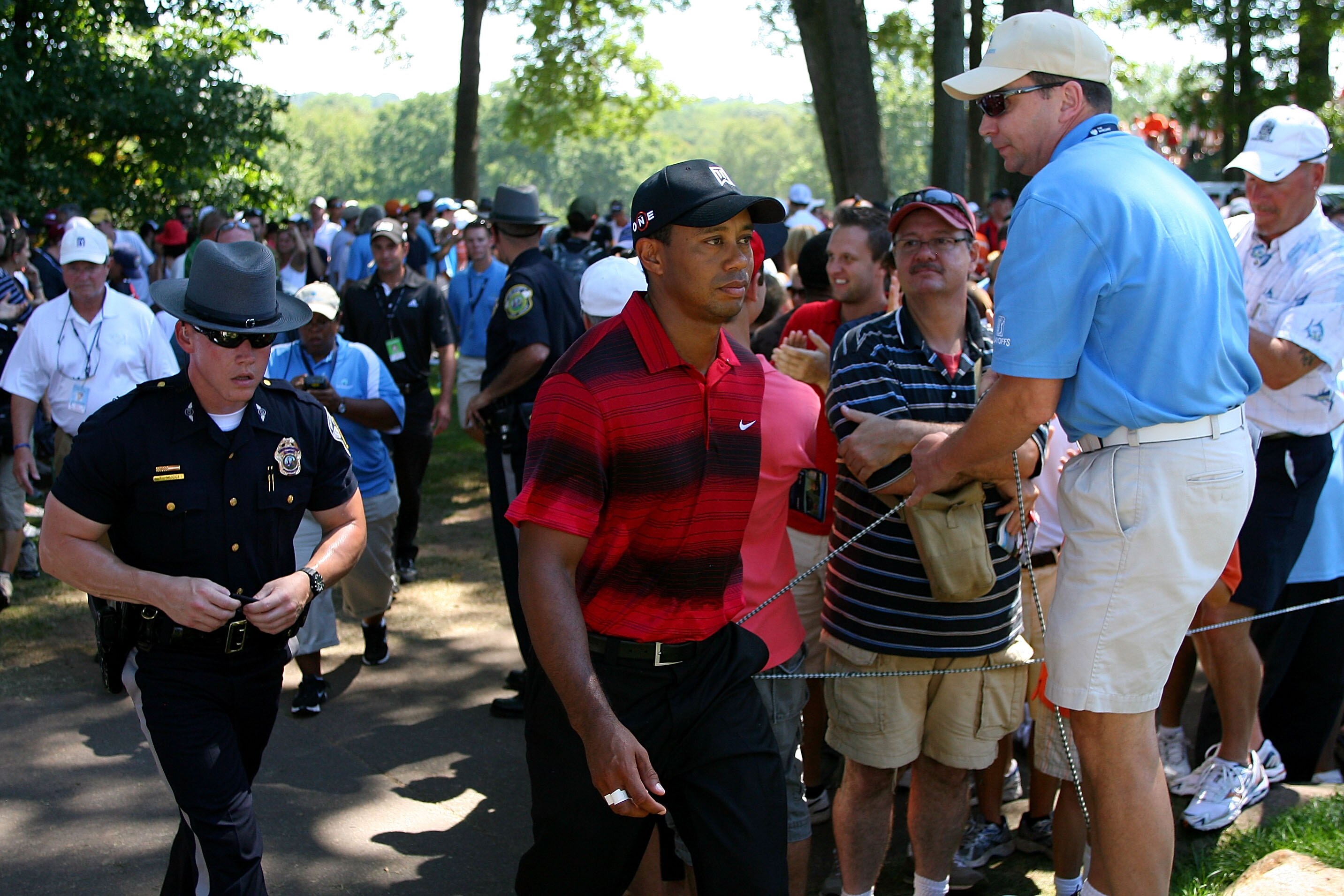 PARAMUS, NJ - AUGUST 29:  Tiger Woods walks through the gallery of fans between the fifth green and the tee box on the sixth hole during the final round of The Barclays at the Ridgewood Country Club on August 29, 2010 in Paramus, New Jersey.  (Photo by Hu