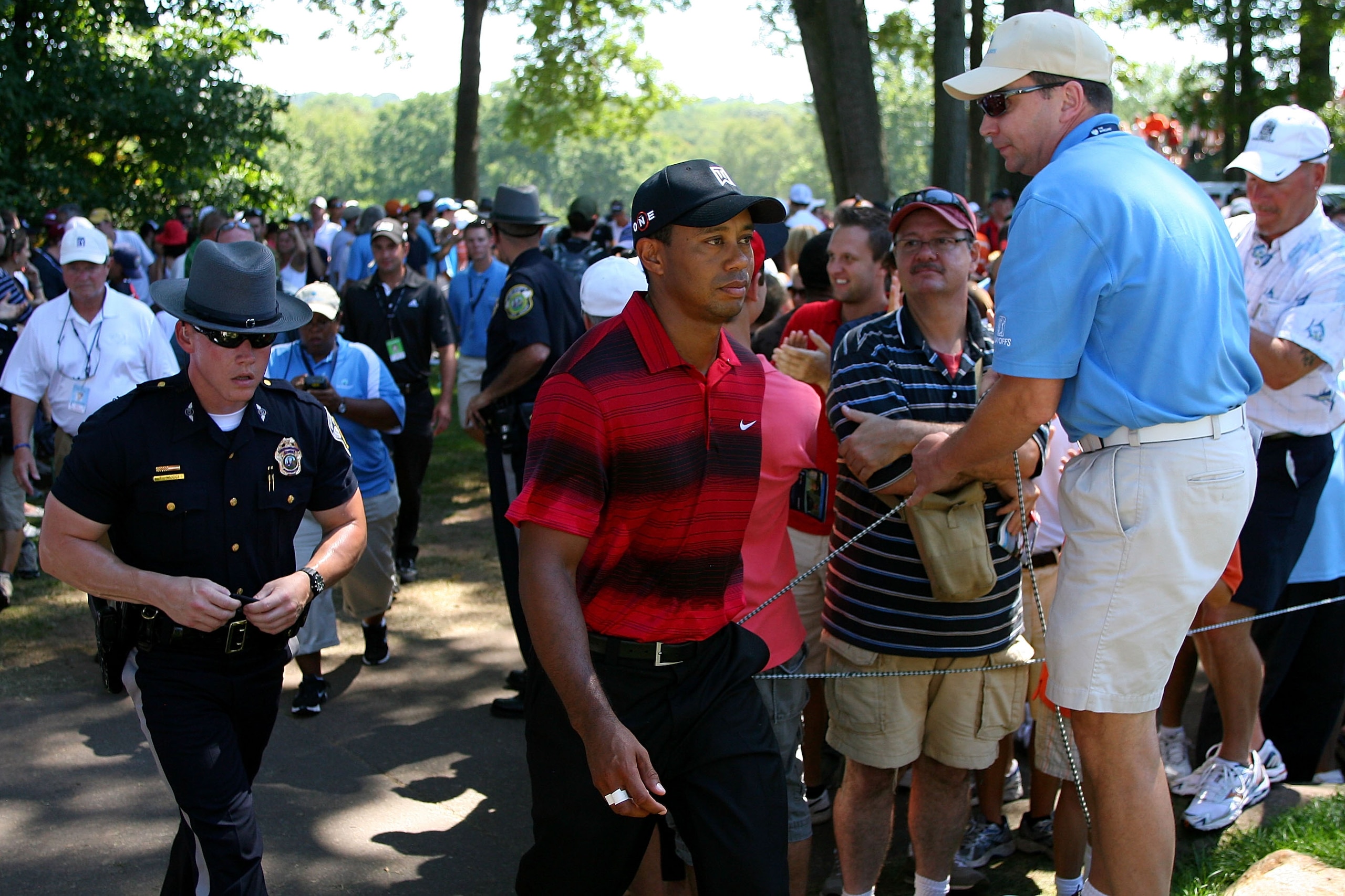 PARAMUS, NJ - AUGUST 29:  Tiger Woods walks through the gallery of fans between the fifth green and the tee box on the sixth hole during the final round of The Barclays at the Ridgewood Country Club on August 29, 2010 in Paramus, New Jersey.  (Photo by Hu