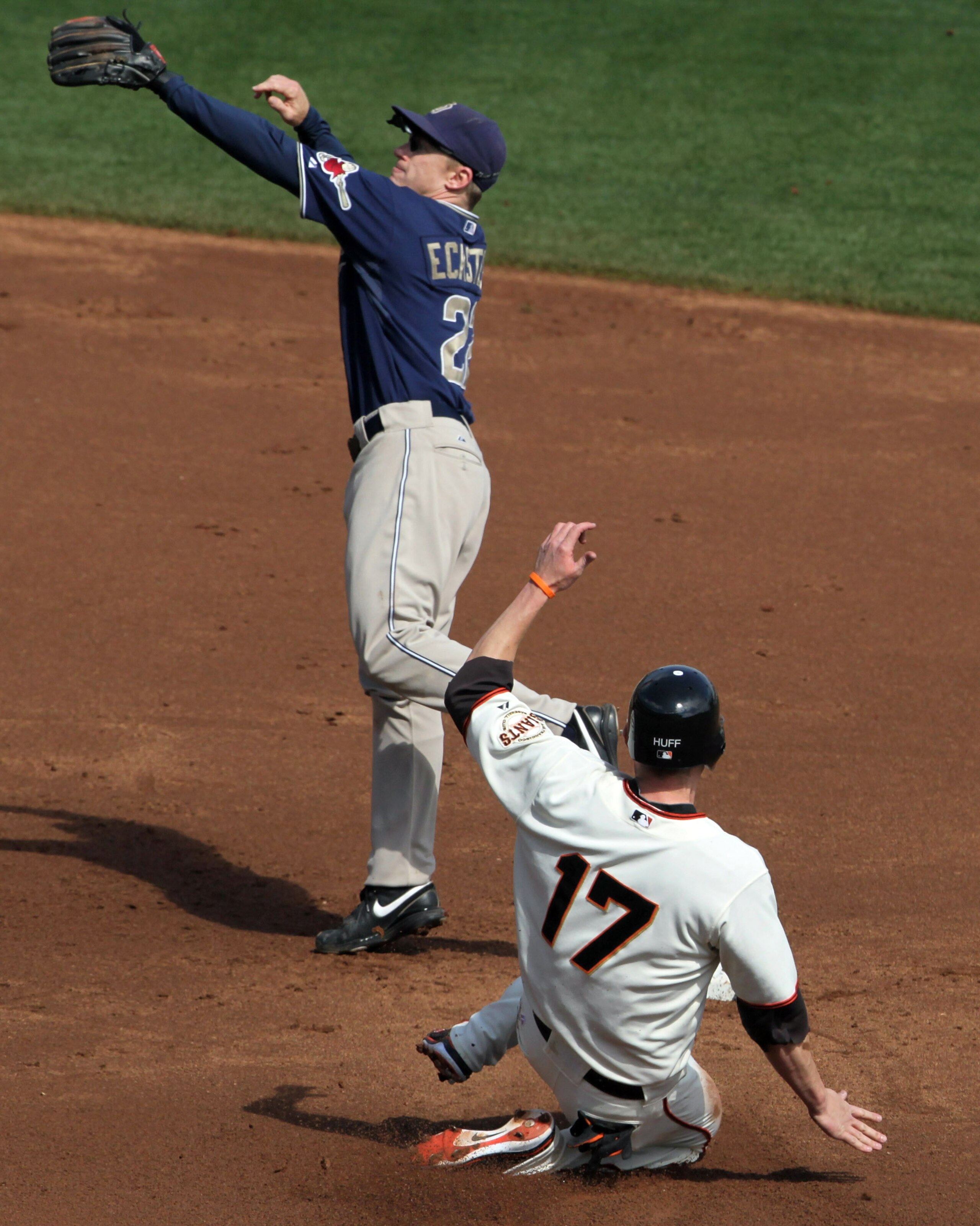 SAN FRANCISCO - OCTOBER 03:  Aubrey Huff #17 of the San Francisco Giants slides into second base on a passed ball as David Eckstein # 22 of the San Diego Padres leaps for the ball during the first inning at AT&T Park on October 3, 2010 in San Francisco, C
