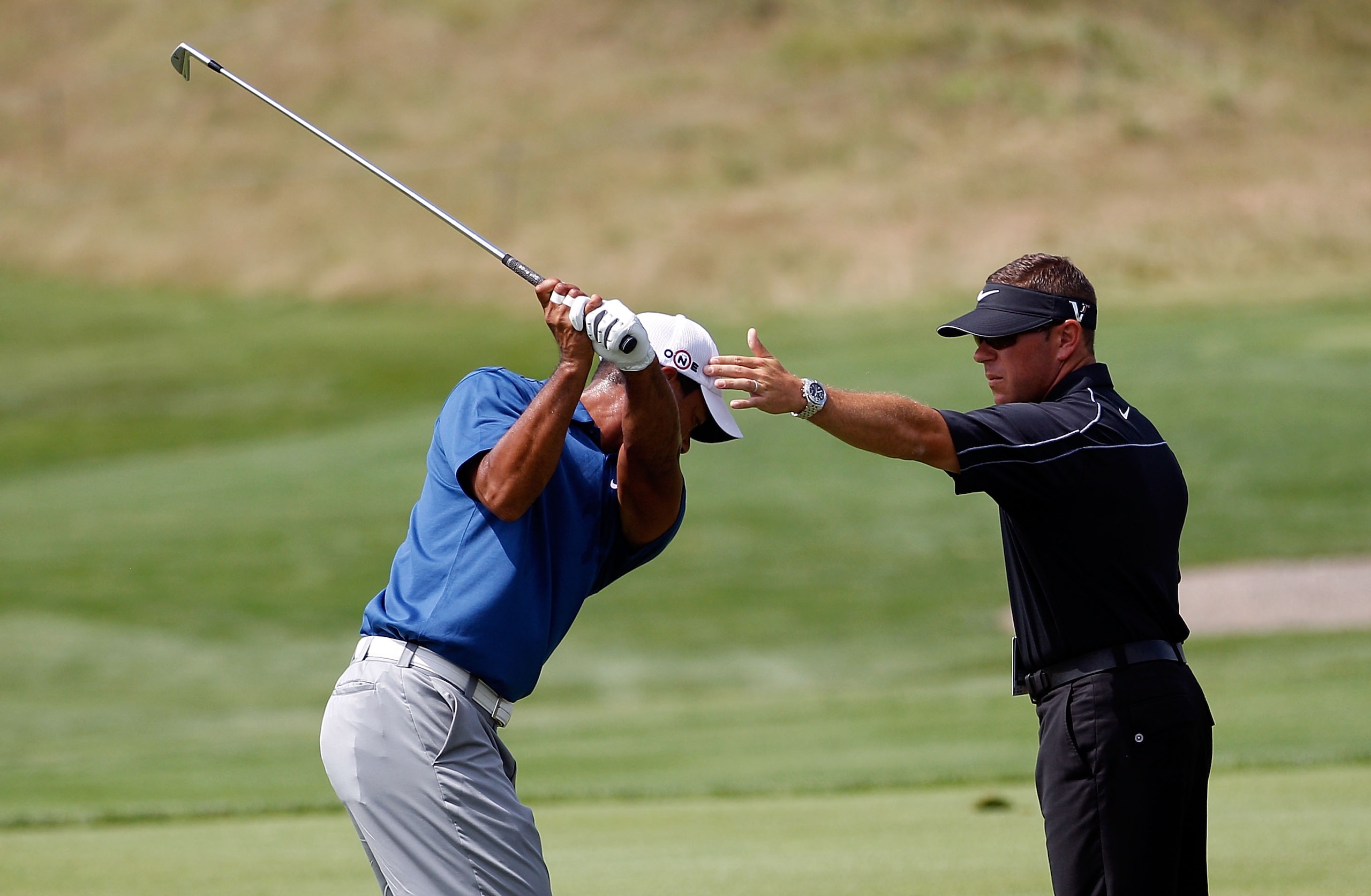 KOHLER, WI - AUGUST 14:  Tiger Woods works with golf instructor Sean Foley on the practice ground prior to the start of the third round of the 92nd PGA Championship on the Straits Course at Whistling Straits on August 14, 2010 in Kohler, Wisconsin.  (Phot