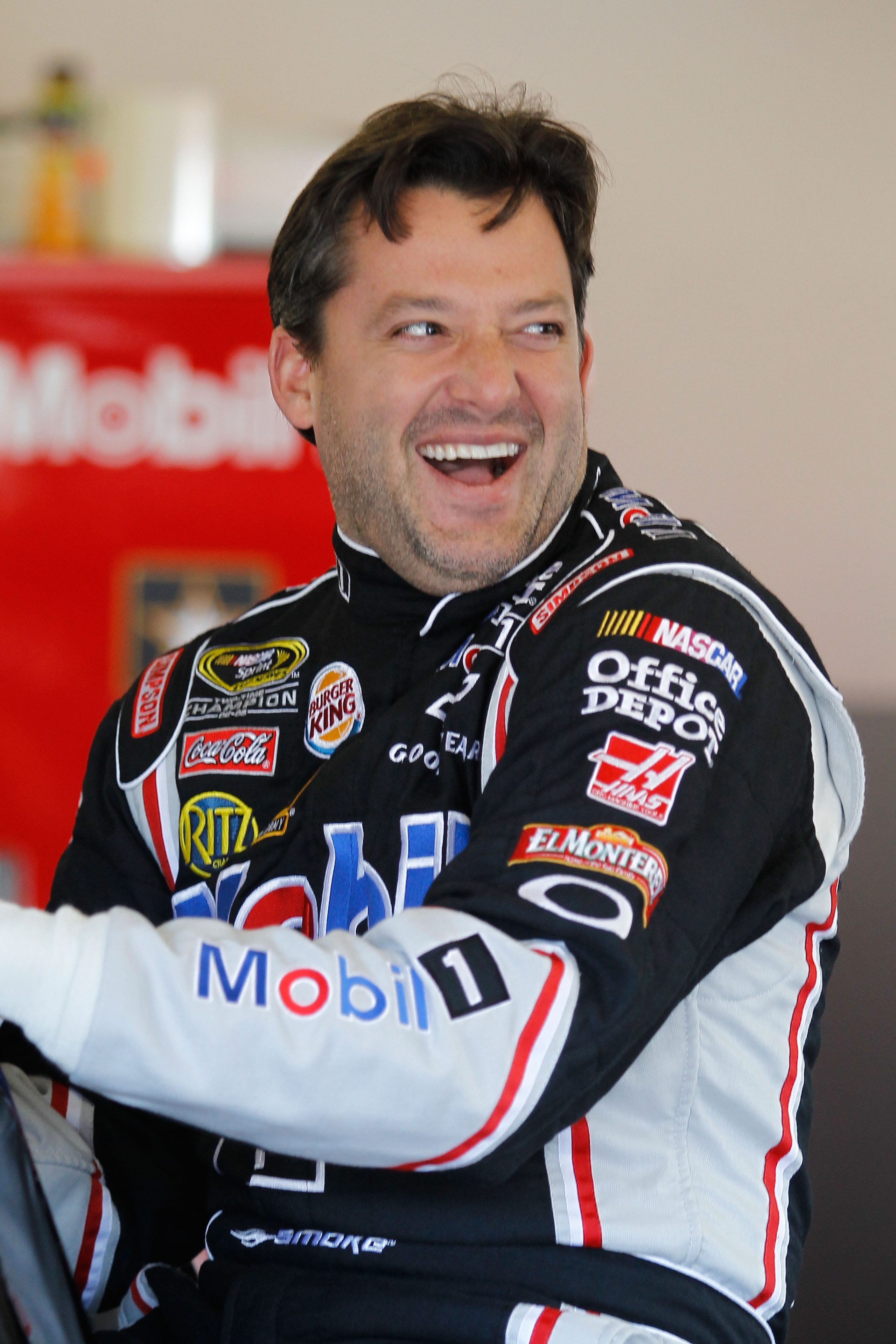DAYTONA BEACH, FL - FEBRUARY 11:  Tony Stewart, driver of the #14 Mobile 1 Chevrolet, looks on from the garage during practice for the NASCAR Budweiser Shootout at Daytona International Speedway on February 11, 2011 in Daytona Beach, Florida.  (Photo by T