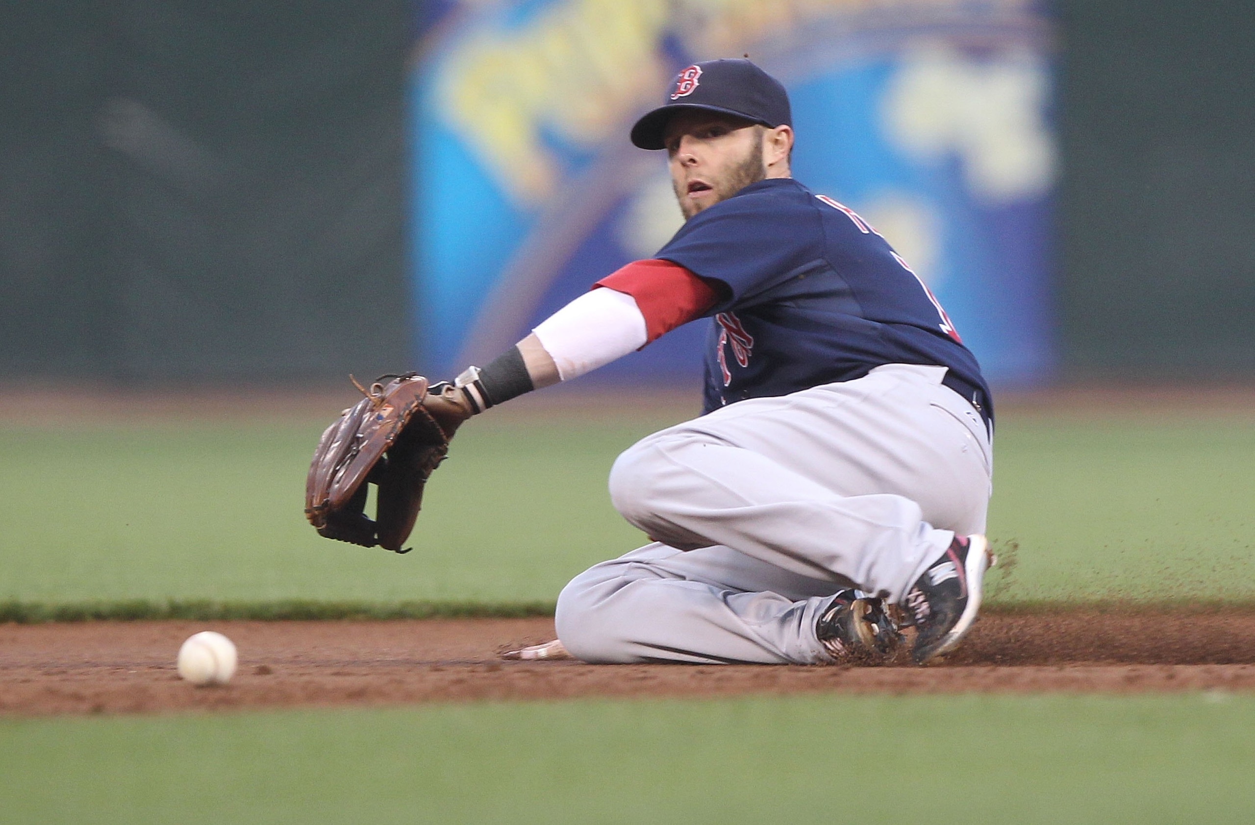 SAN FRANCISCO - JUNE 25:  Dustin Pedroia #15 of the Boston Red Sox fields a ball against the San Francisco Giants during an MLB game at AT&T Park on June 25, 2010 in San Francisco, California. Pedroia left the game later in the inning.  (Photo by Jed Jaco
