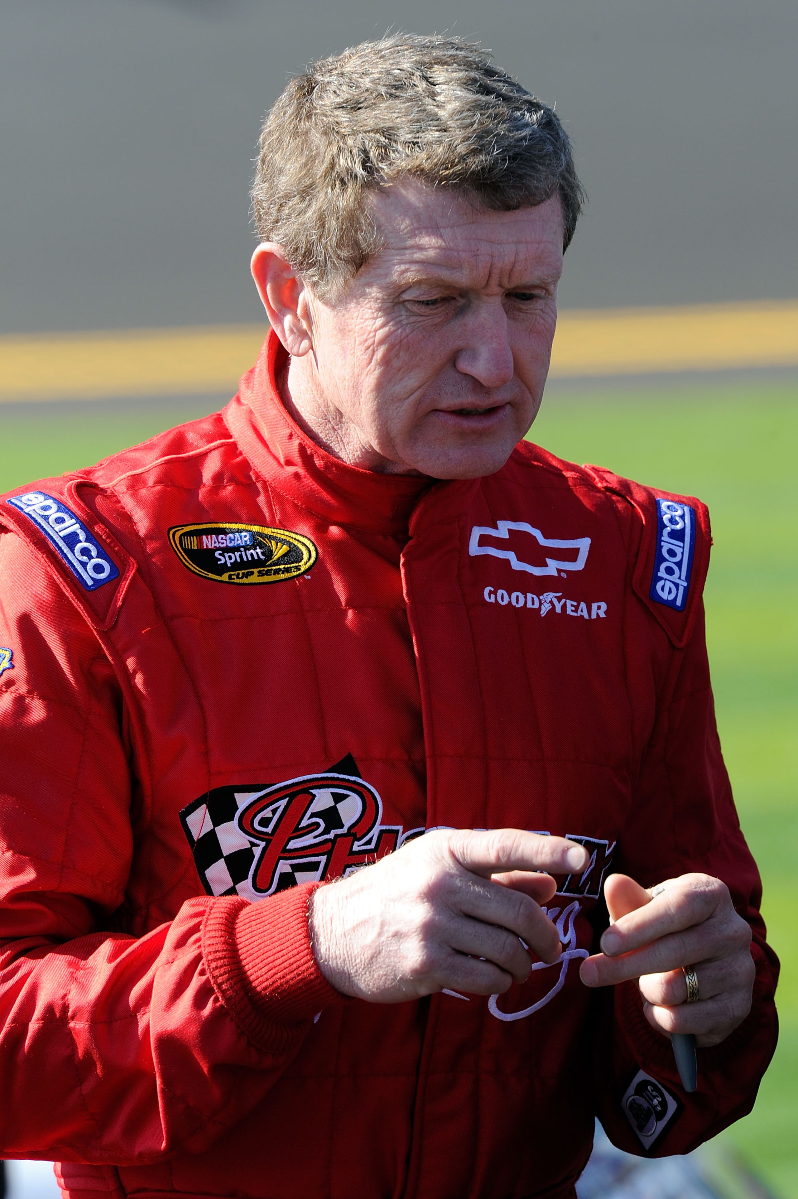 DAYTONA BEACH, FL - FEBRUARY 13:  Bill Elliott, driver of the #09 Phoenix Construction Chevrolet, stands on the grid during qualifying for the NASCAR Sprint Cup Series Daytona 500 at Daytona International Speedway on February 13, 2011 in Daytona Beach, Fl