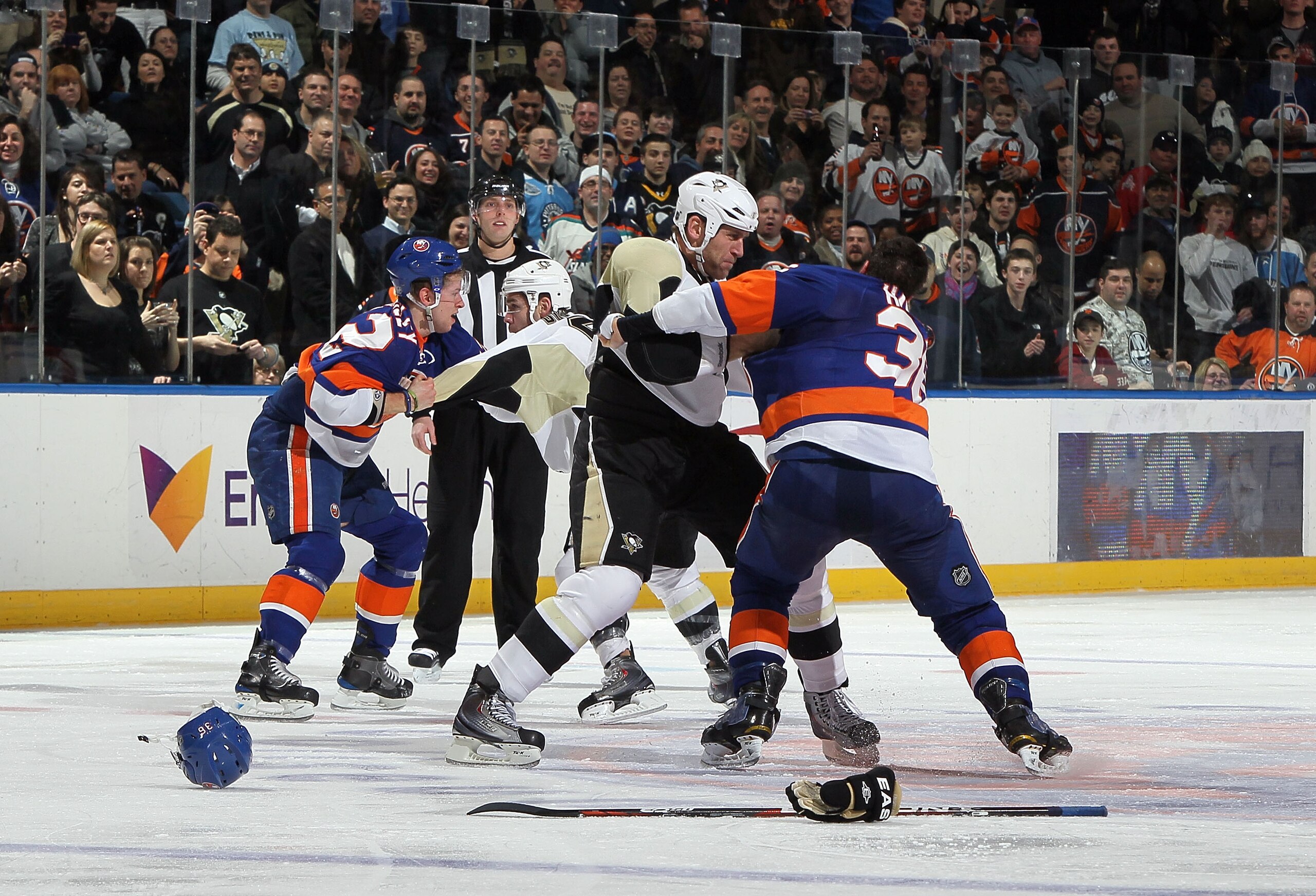 UNIONDALE, NY - FEBRUARY 11:  Travis Hamonic #36 of the New York Islanders fights Michael Rupp #17 of the Pittsburgh Penguins as teammates Josh Bailey #12 duels Pascal Dupuis #9 during the second period on February 11, 2011 at Nassau Coliseum in Uniondale