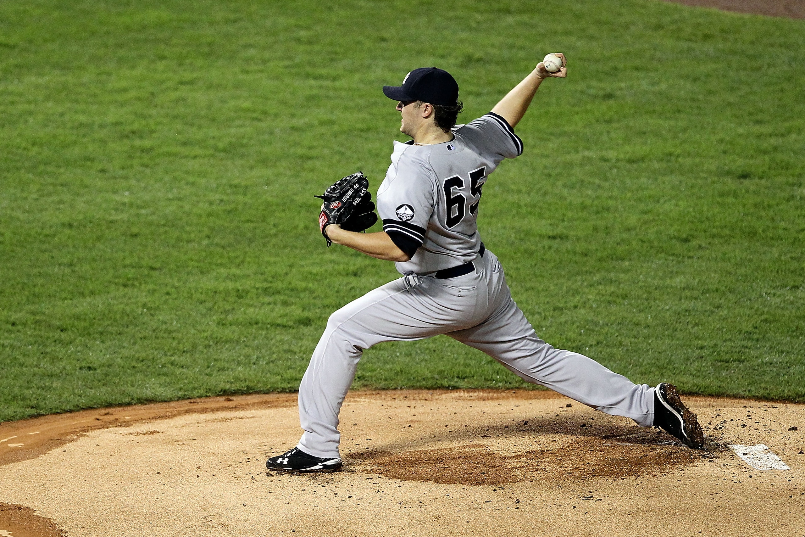 ARLINGTON, TX - OCTOBER 22:  Phil Hughes #65 of the New York Yankees throws a pitch against the Texas Rangers in Game Six of the ALCS during the 2010 MLB Playoffs at Rangers Ballpark in Arlington on October 22, 2010 in Arlington, Texas.  (Photo by Ronald