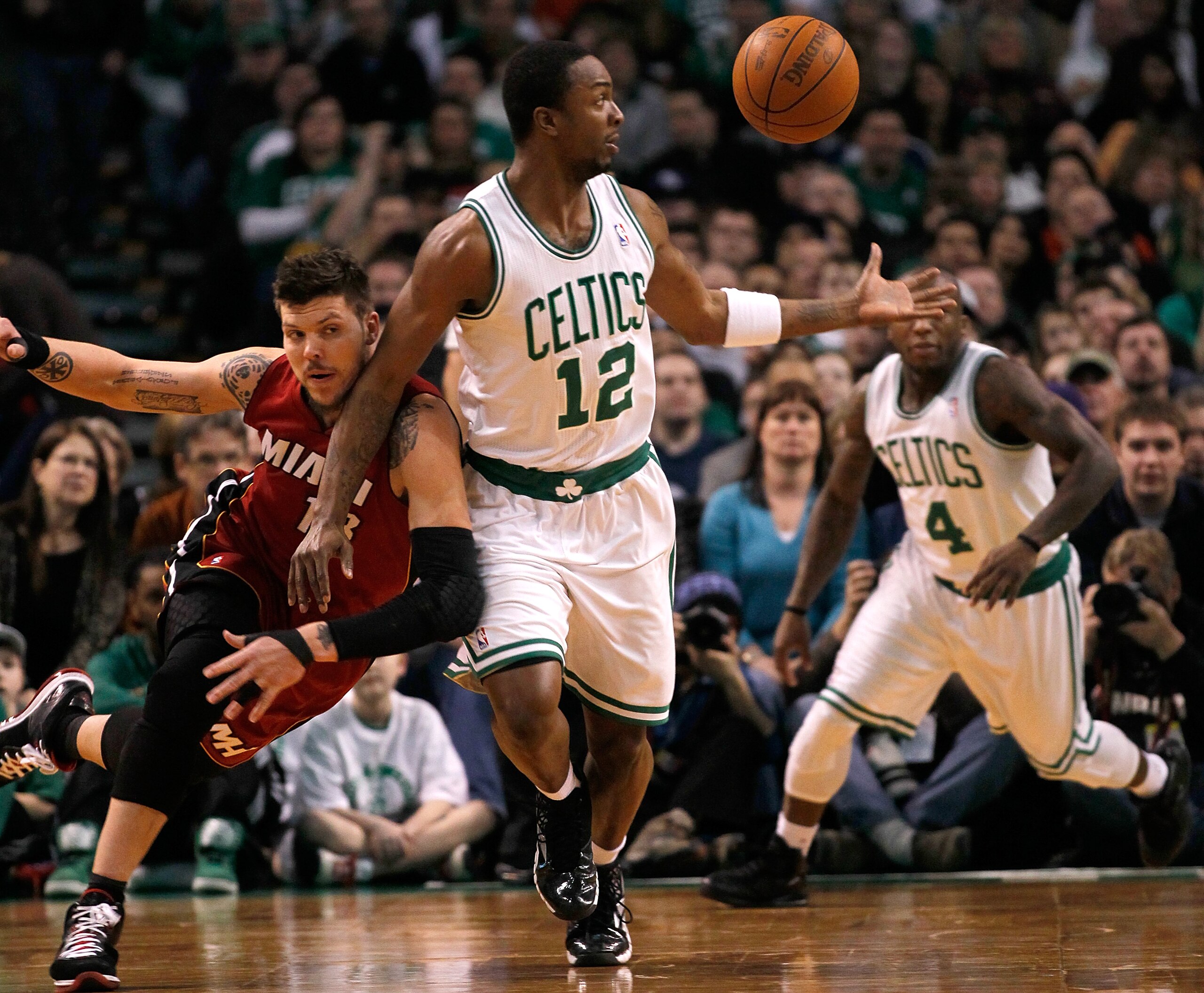 BOSTON - FEBRUARY 13:  Von Wafer #12 of the Boston Celtics battles Dexter Pittman #13 of the Miami Heat for a loose ball at TD Garden on February 13, 2011 in Boston, Massachusetts. The Celtics won 85-82. NOTE TO USER: User expressly acknowledges and agree
