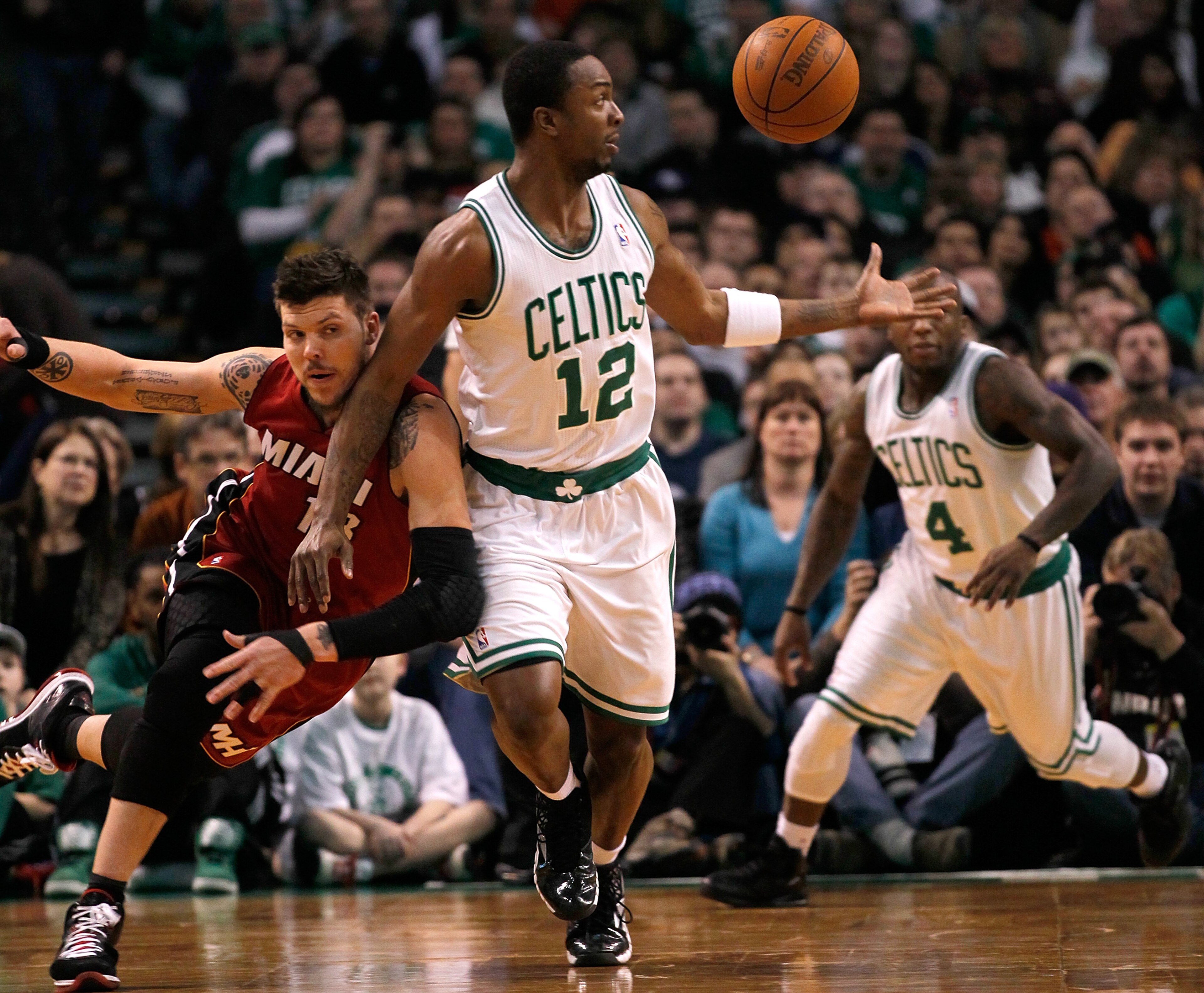BOSTON - FEBRUARY 13:  Von Wafer #12 of the Boston Celtics battles Dexter Pittman #13 of the Miami Heat for a loose ball at TD Garden on February 13, 2011 in Boston, Massachusetts. The Celtics won 85-82. NOTE TO USER: User expressly acknowledges and agree