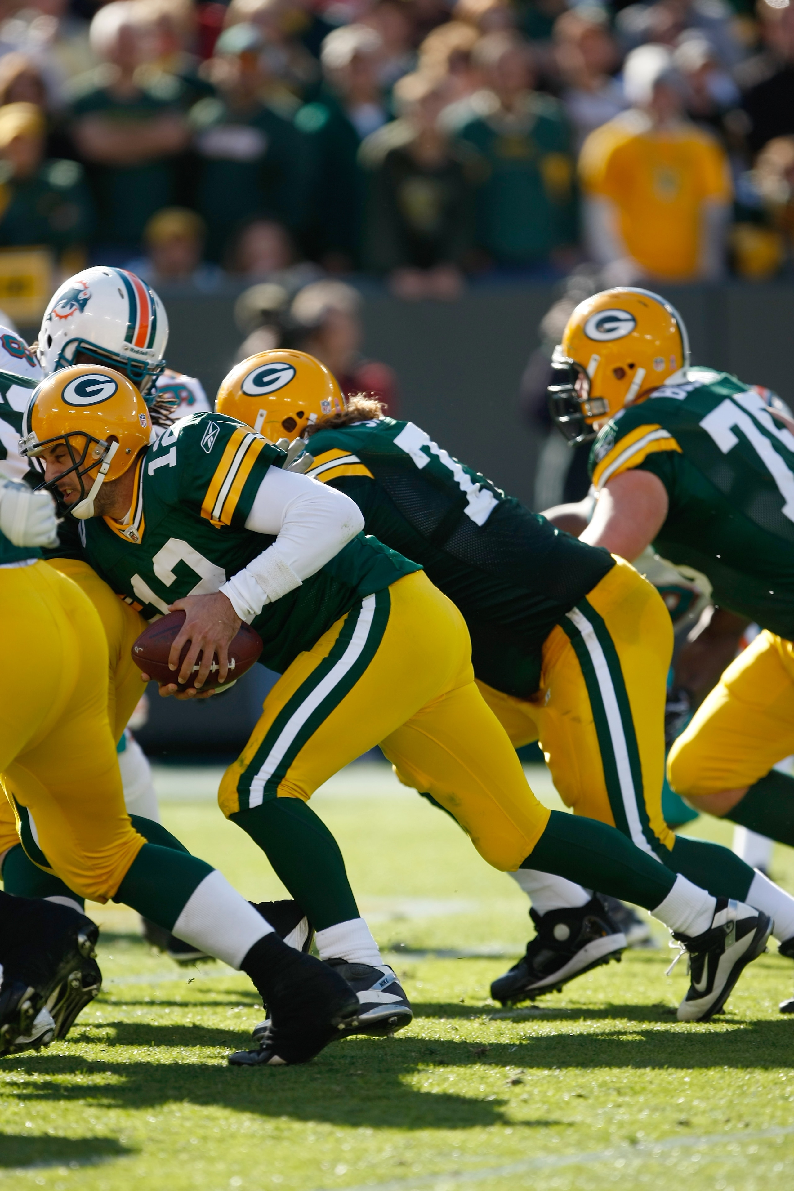 GREEN BAY, WI - OCTOBER 17: Aaron Rogers #12 of the Green Bay Packers runs for a touchdown to tie the game against the Miami Dolphins at Lambeau Field on October 17, 2010 in Green Bay, Wisconsin. The Dolphins defeated the Packers 23-20 in overtime. (Photo