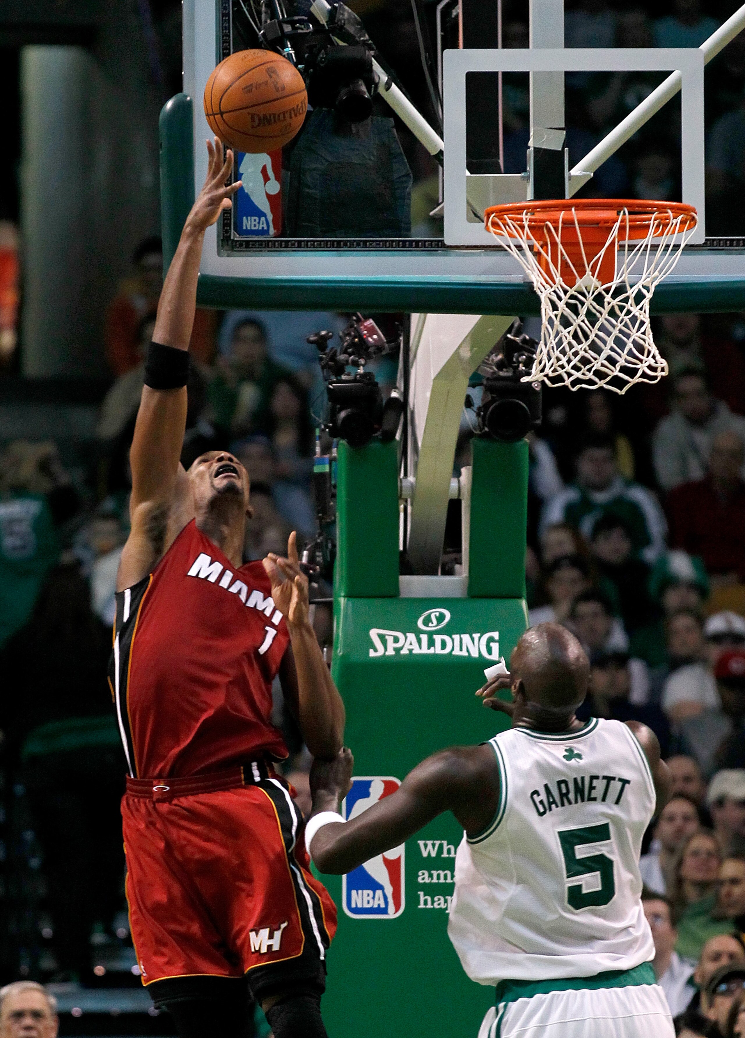 BOSTON - FEBRUARY 13:  Chris Bosh #1 of the Miami Heat goes to the basket against Kevin Garnett #5 of the Boston Celtics at TD Garden on February 13, 2011 in Boston, Massachusetts. NOTE TO USER: User expressly acknowledges and agrees that, by downloading