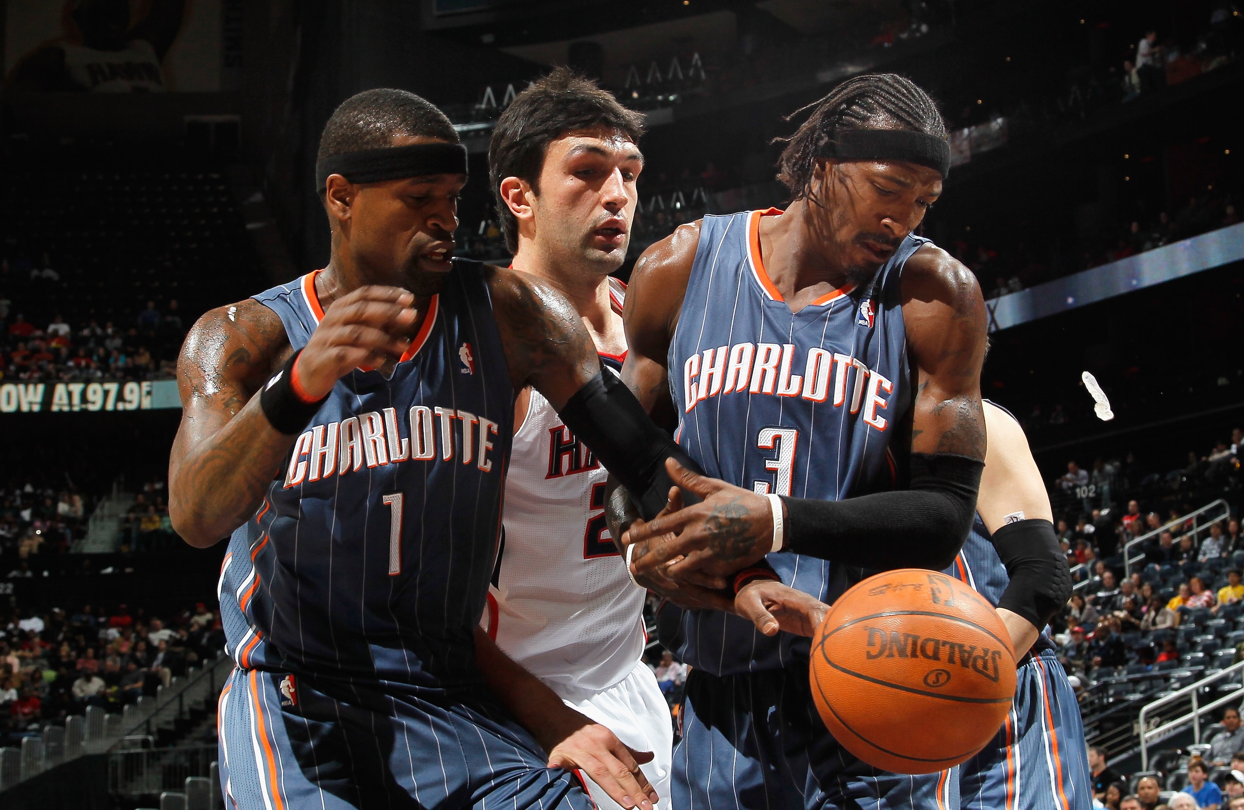 ATLANTA, GA - FEBRUARY 12:  Zaza Pachulia #27 of the Atlanta Hawks battles for a rebound against Gerald Wallace #3 and Stephen Jackson #1 of the Charlotte Bobcats at Philips Arena on February 12, 2011 in Atlanta, Georgia.  NOTE TO USER: User expressly ack