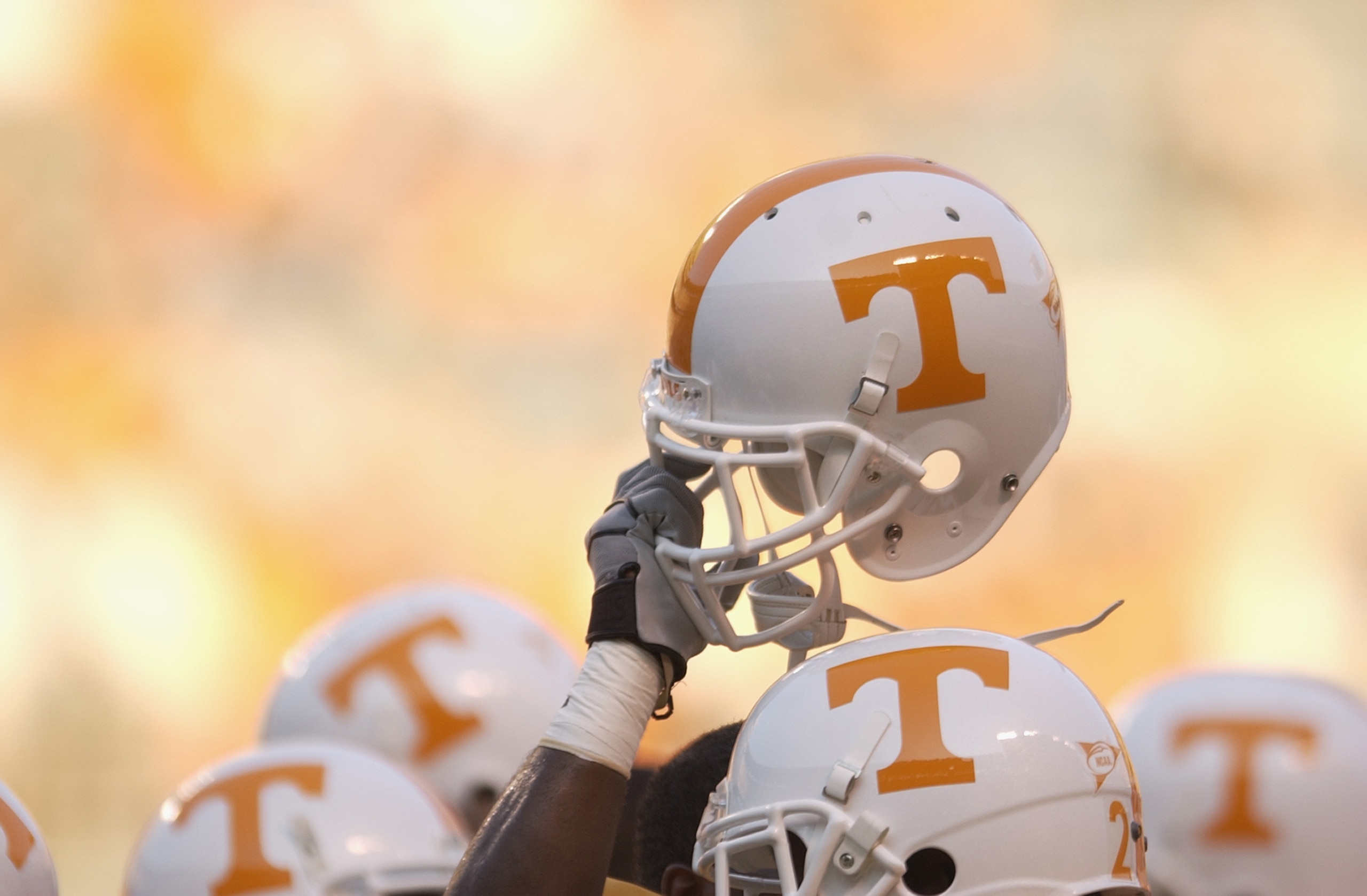 KNOXVILLE, TN - SEPTEMBER 7:  A Tennessee Volunteer holds up his helmet in the team huddle before the NCAA football game against the Middle Tennessee State Blue Raiders at Neyland Stadium on September 7, 2002 in Knoxville, Tennessee. Tennessee won 26-3. (
