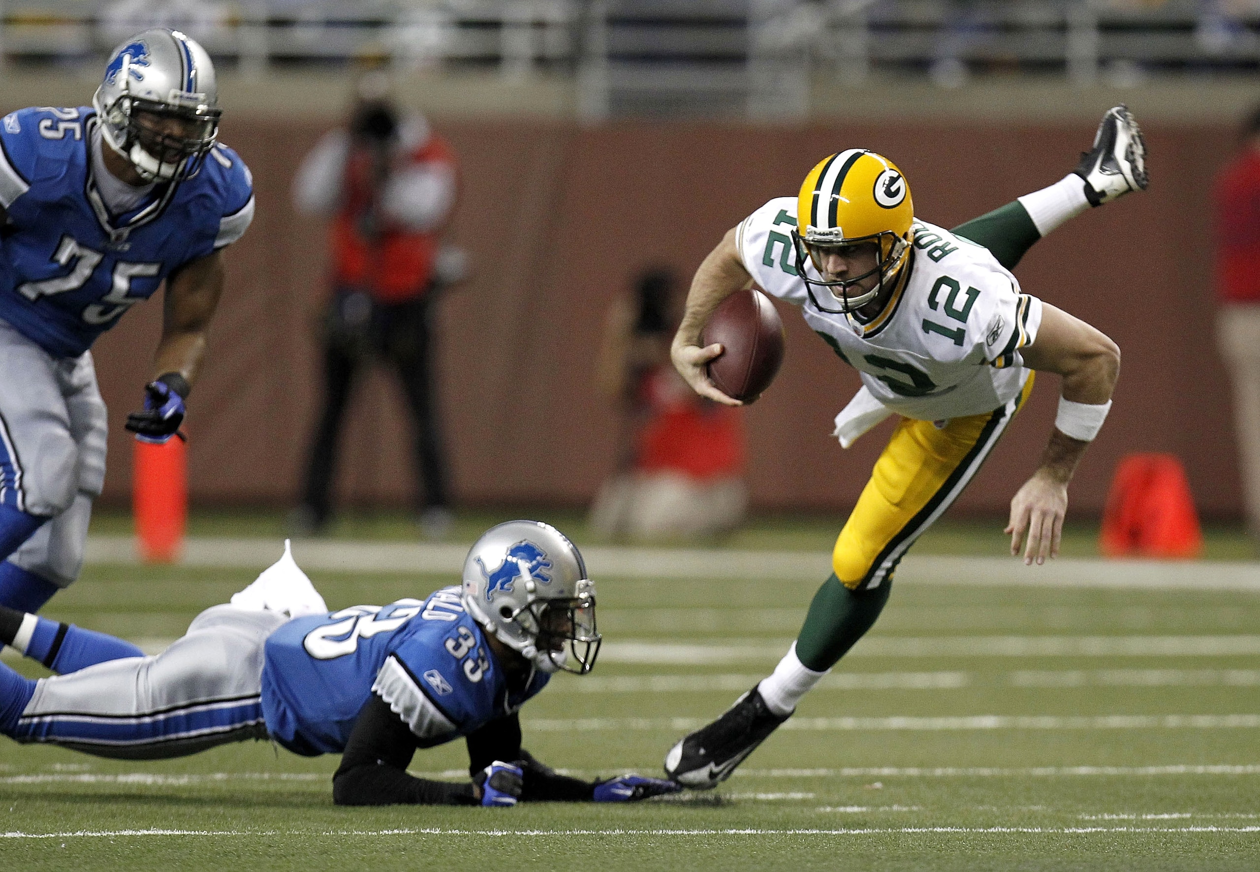 DETROIT, MI - DECEMBER 12:  Aaron Rodgers #12 of the Green Bay Packers is tackled during a second half run by Brandon McDonald #33 of the Detroit Lions on December 12, 2010 at Ford Field in Detroit, Michigan.  (Photo by Gregory Shamus/Getty Images)