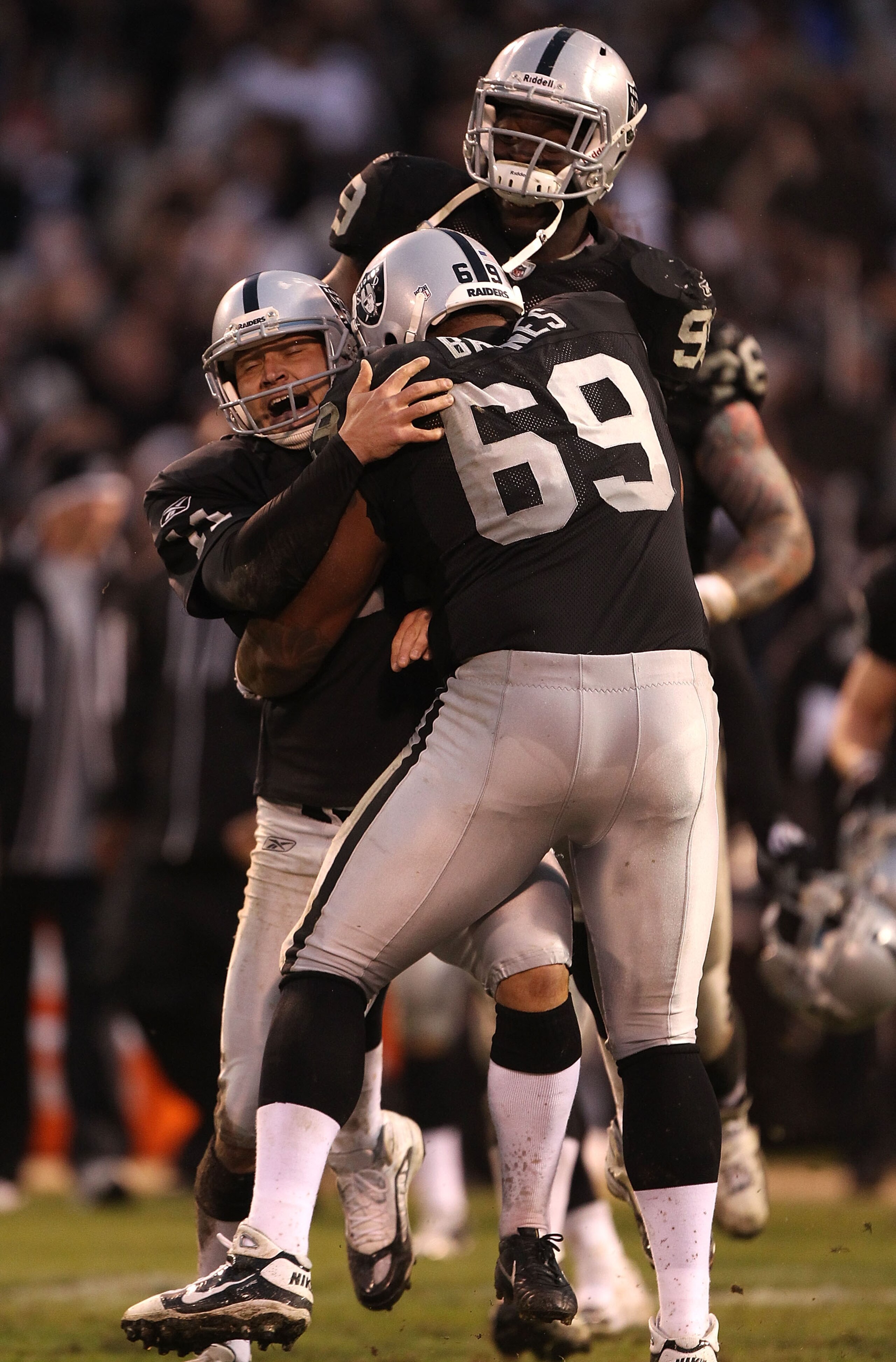 OAKLAND, CA - NOVEMBER 07: Sebastian Janikowski #11 of the Oakland Raiders celebrates with Jared Veldheer #29 and Lamarr Houston #99 after kicking the game winning field goal in overtime against the Kansas City Chiefs during an NFL game at Oakland-Alameda