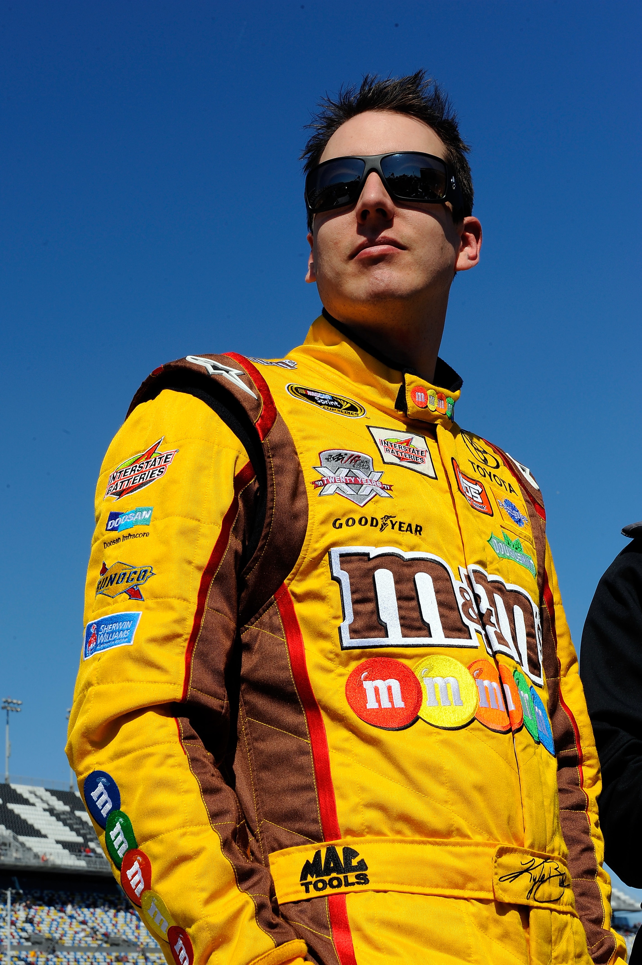 DAYTONA BEACH, FL - FEBRUARY 13:  Kyle Busch, driver of the #18 M&M's Toyota, stands on the grid during qualifying for the NASCAR Sprint Cup Series Daytona 500 at Daytona International Speedway on February 13, 2011 in Daytona Beach, Florida.  (Photo by Ja