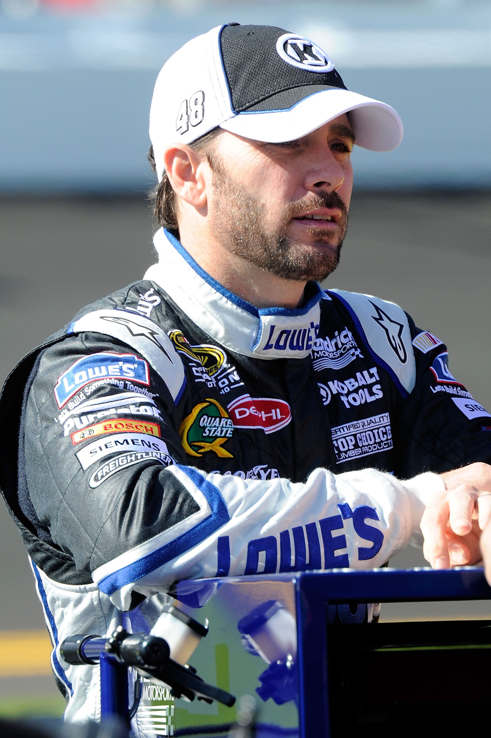 DAYTONA BEACH, FL - FEBRUARY 13:  Jimmie Johnson, driver of the #48 Lowe's Chevrolet, stands on the grid during qualifying for the NASCAR Sprint Cup Series Daytona 500 at Daytona International Speedway on February 13, 2011 in Daytona Beach, Florida.  (Pho