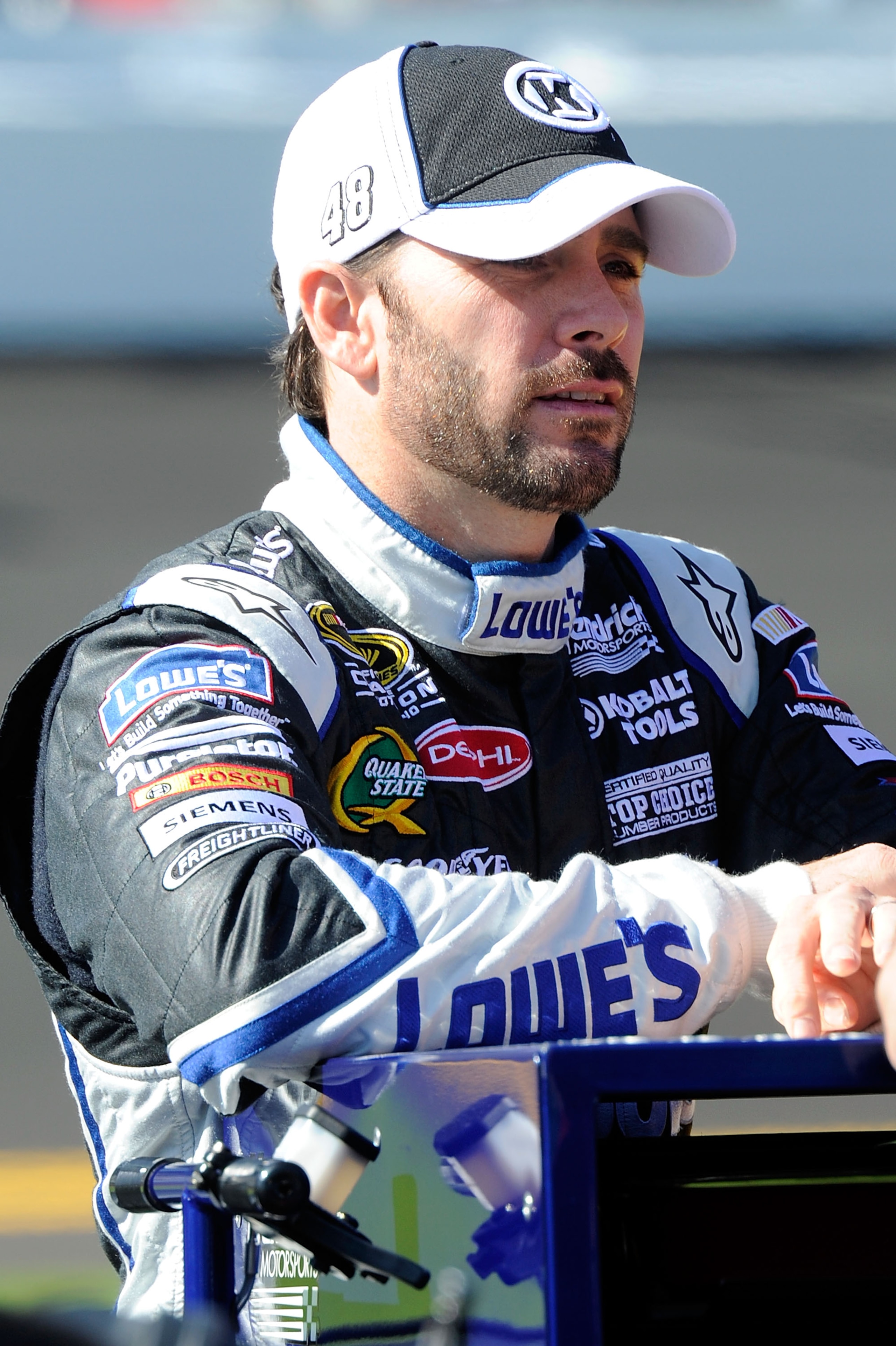 DAYTONA BEACH, FL - FEBRUARY 13:  Jimmie Johnson, driver of the #48 Lowe's Chevrolet, stands on the grid during qualifying for the NASCAR Sprint Cup Series Daytona 500 at Daytona International Speedway on February 13, 2011 in Daytona Beach, Florida.  (Pho