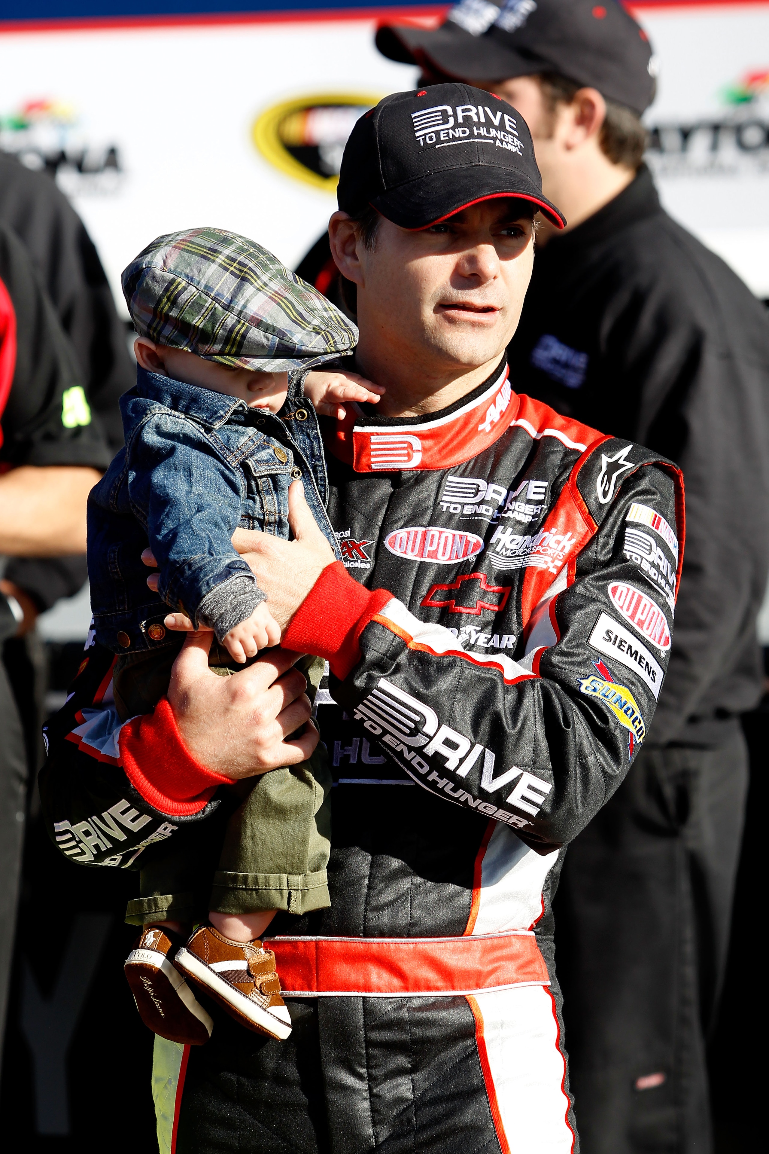 DAYTONA BEACH, FL - FEBRUARY 13:  Front Row award winner Jeff Gordon, driver of the #24 Drive to End Hunger Chevrolet, poses with his son Leo Gordon in victory lane after qualifying for the NASCAR Sprint Cup Series Daytona 500 at Daytona International Spe