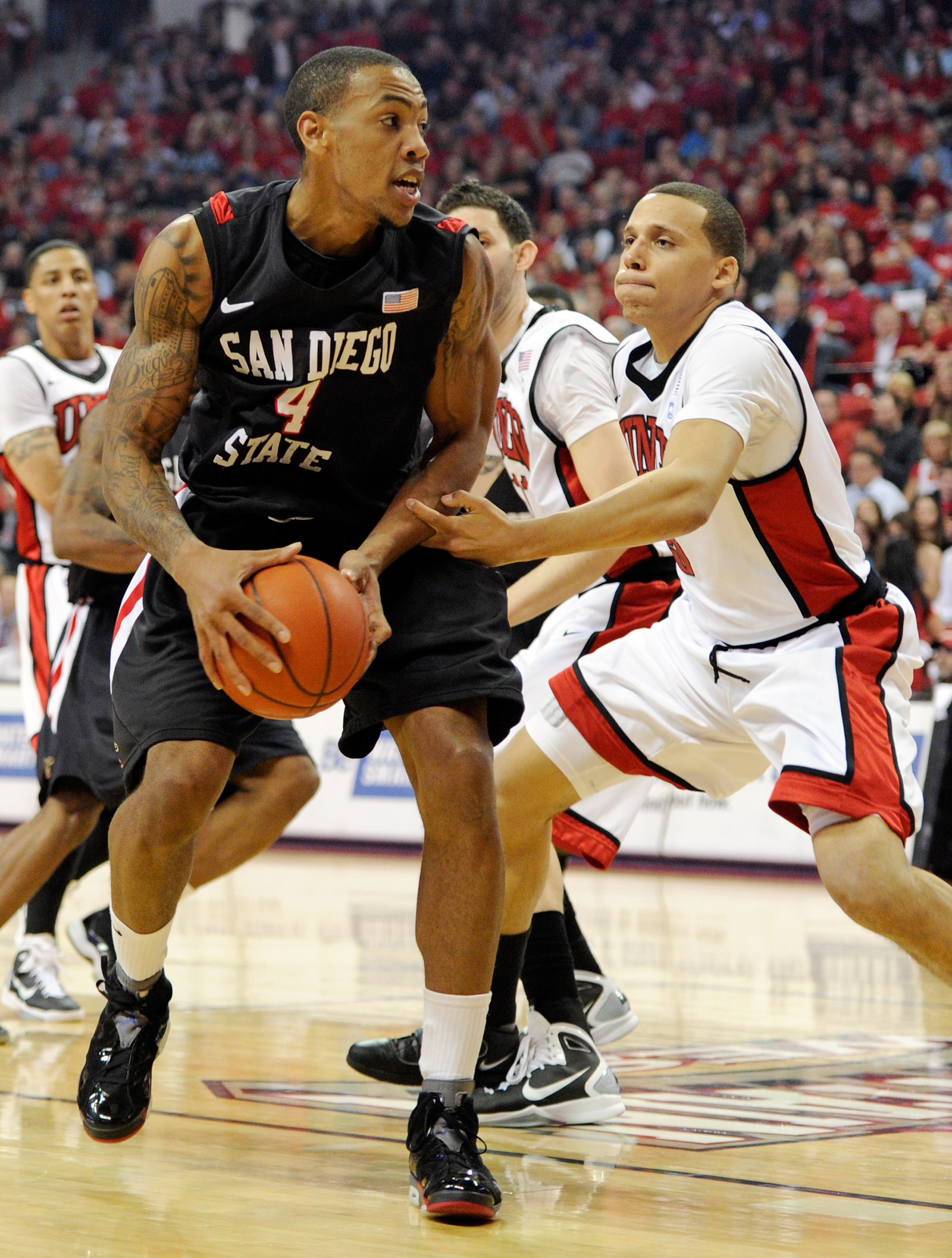 LAS VEGAS, NV - FEBRUARY 12:  Malcolm Thomas #4 of the San Diego State Aztecs goes to the basket against Chace Stanback #22 of the UNLV Rebels during their game at the Thomas & Mack Center February 12, 2011 in Las Vegas, Nevada. San Diego State won 63-57.