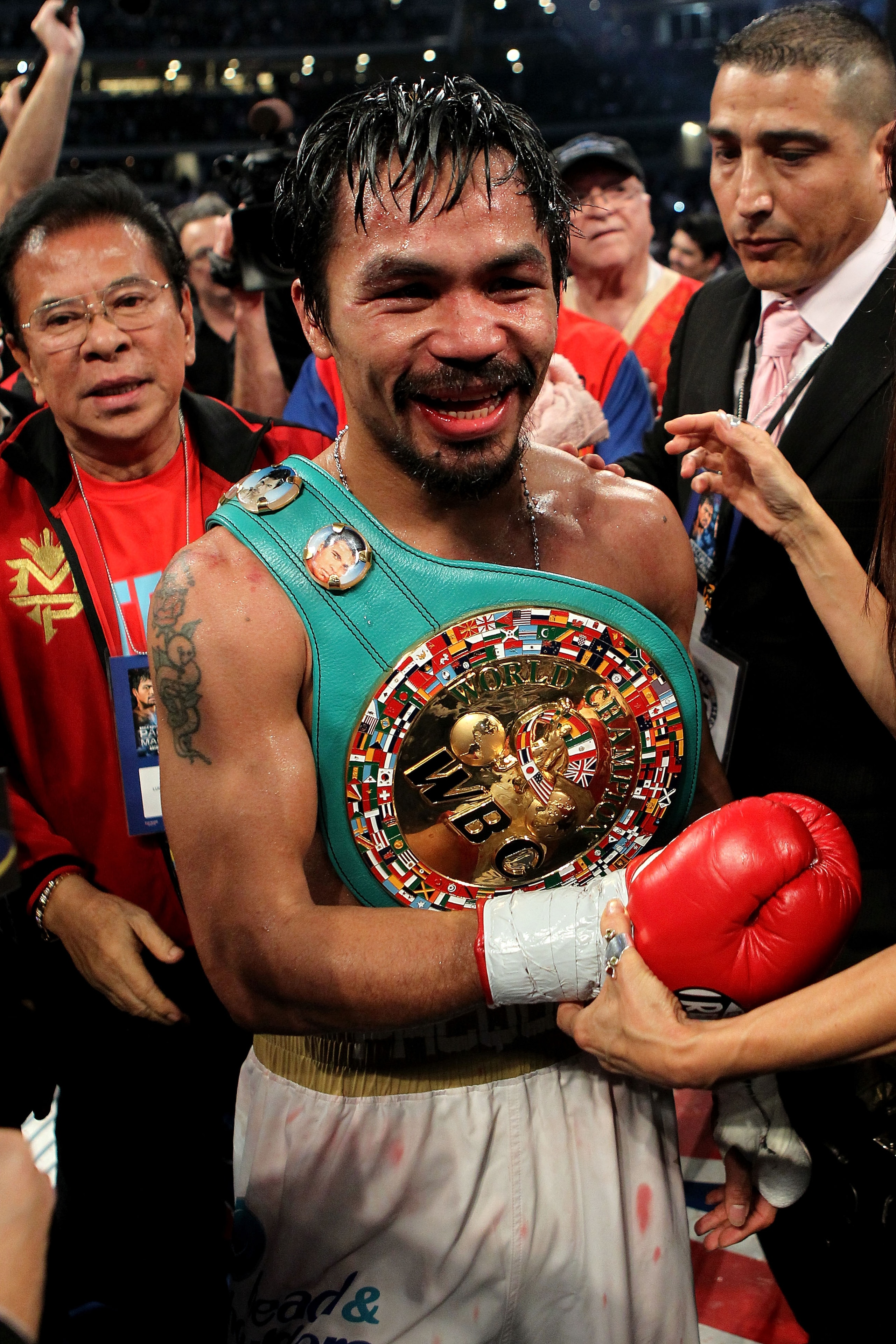 ARLINGTON, TX - NOVEMBER 13: Manny Pacquiao (white trunks) of the Philippines celebrates after he was declared the winner by a unanimous decision against Antonio Margarito (black trunks) of Mexico during their WBC World Super Welterweight Title bout at C ARLINGTON, TX - NOVEMBER 13: Manny Pacquiao (white trunks) of the Philippines celebrates after he was declared the winner by a unanimous decision against Antonio Margarito (black trunks) of Mexico during their WBC World Super Welterweight Title bout at C