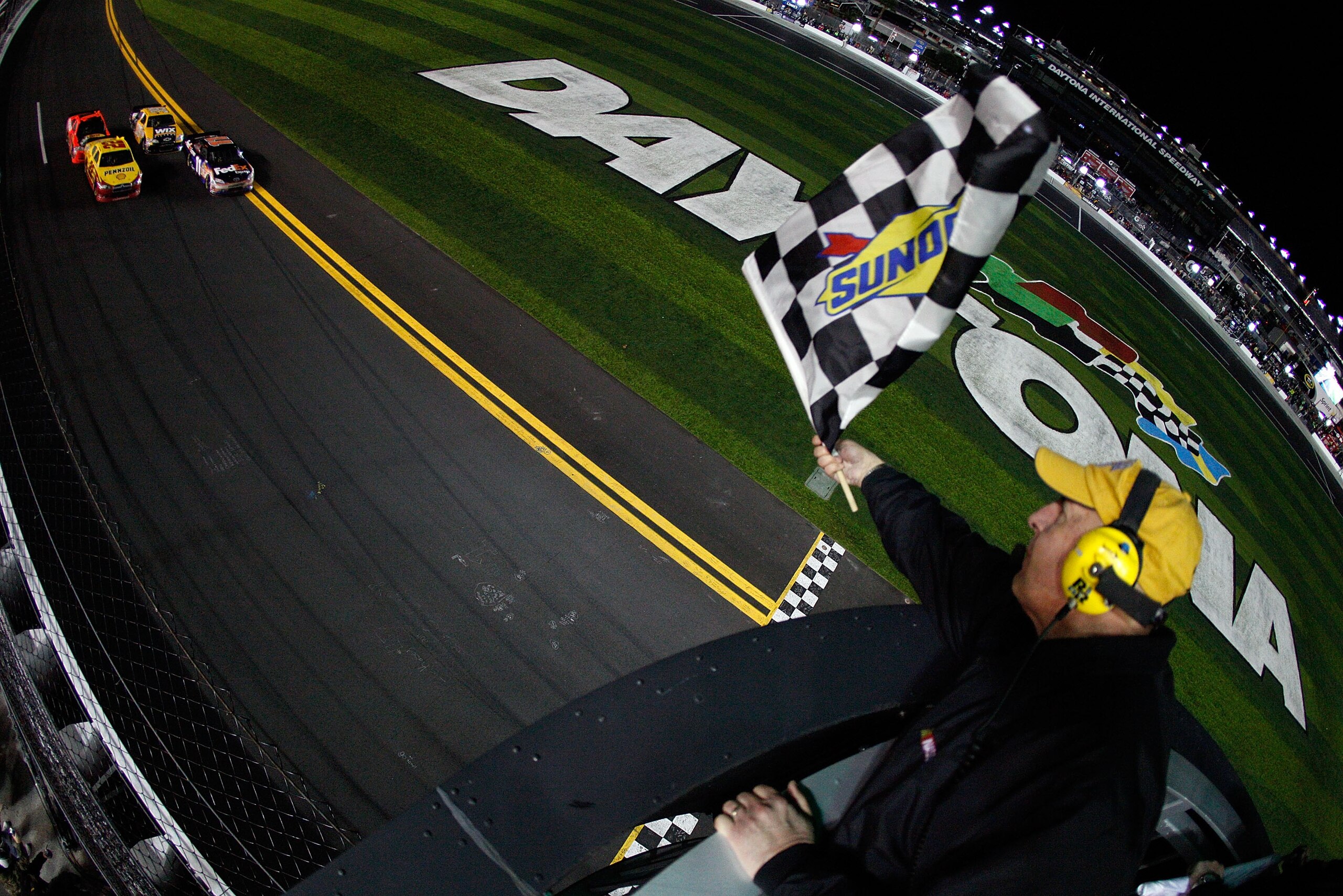 DAYTONA BEACH, FL - FEBRUARY 12:  Kurt Busch, driver of the #22 Shell/Pennzoil Dodge, comes to the finish line to win the NASCAR Budweiser Shootout ahead of Denny Hamlin, driver of the #11 FedEx Toyota, Jamie McMurray, driver of the #1 Bass Pro Shops Chev