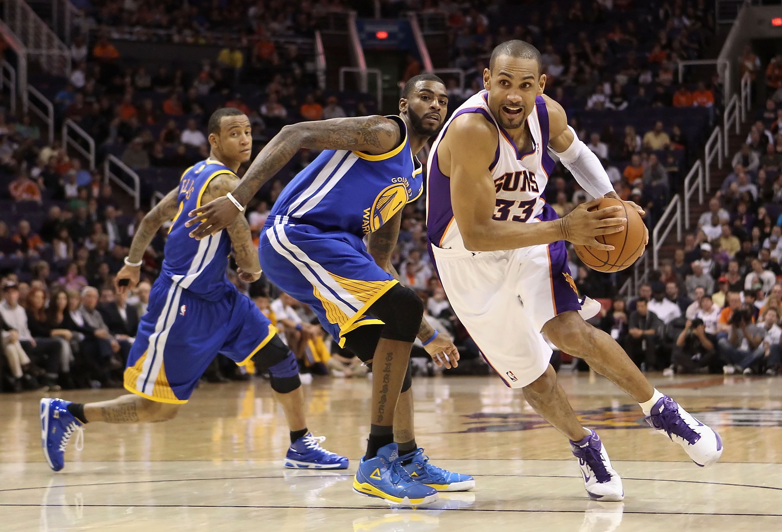 PHOENIX, AZ - FEBRUARY 10:  Grant Hill #33 of the Phoenix Suns drives the ball past Dorell Wright #1 of the Golden State Warriors during the NBA game at US Airways Center on February 10, 2011 in Phoenix, Arizona.  The Suns defeated the Warriors 112-88.  N