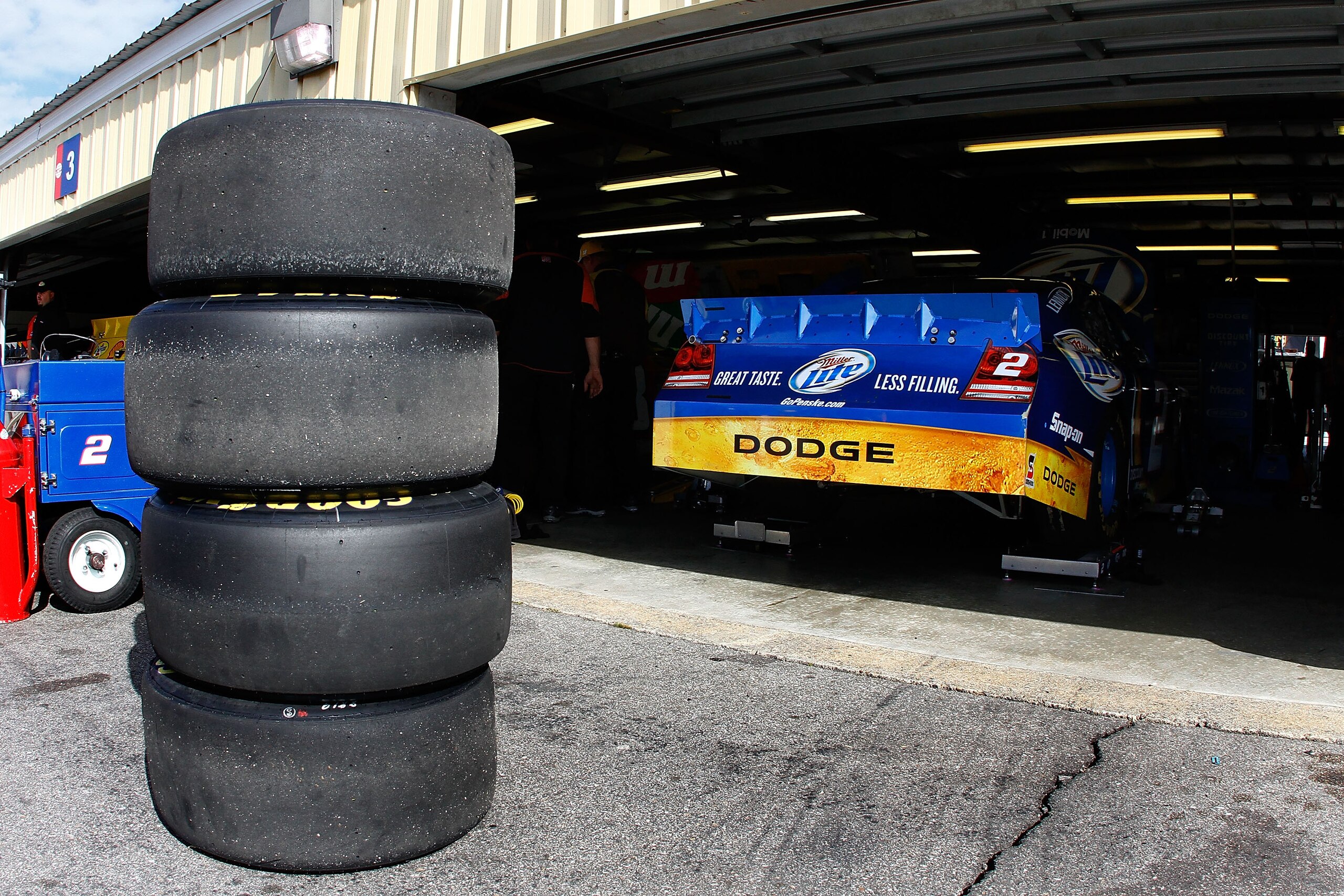 LOUDON, NH - SEPTEMBER 18:  A stack of tires are seen next to the #2 Miller Lite Dodge driven by Kurt Busch (not pictured) in the garage area during practice for the NASCAR Sprint Cup Series Sylvania 300 at New Hampshire Motor Speedway on September 18, 20