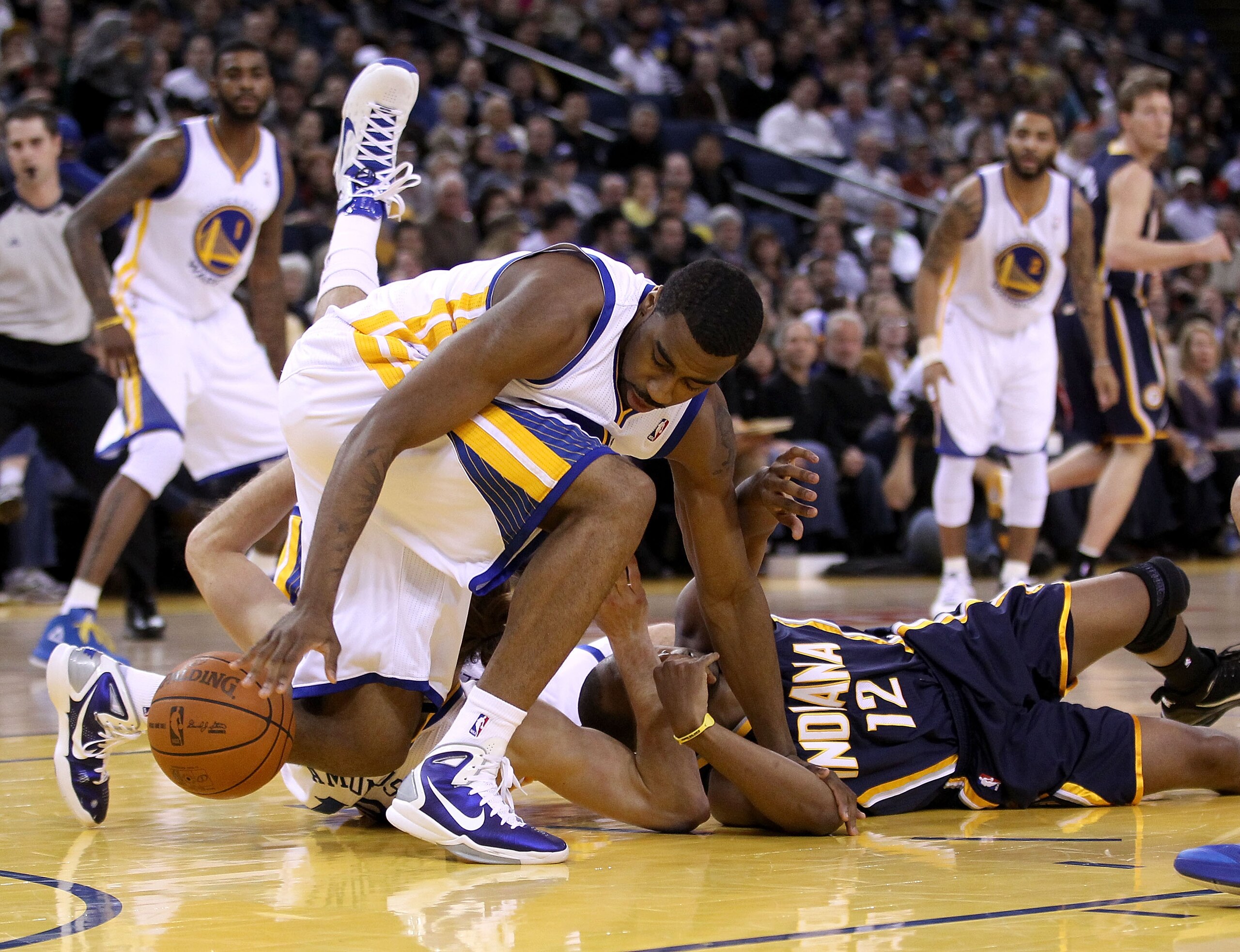 OAKLAND, CA - JANUARY 19:  A.J. Price #12 of the Indiana Pacers has the ball stolen by Reggie Williams #55 of the Golden State Warriors at Oracle Arena on January 19, 2011 in Oakland, California.  NOTE TO USER: User expressly acknowledges and agrees that,